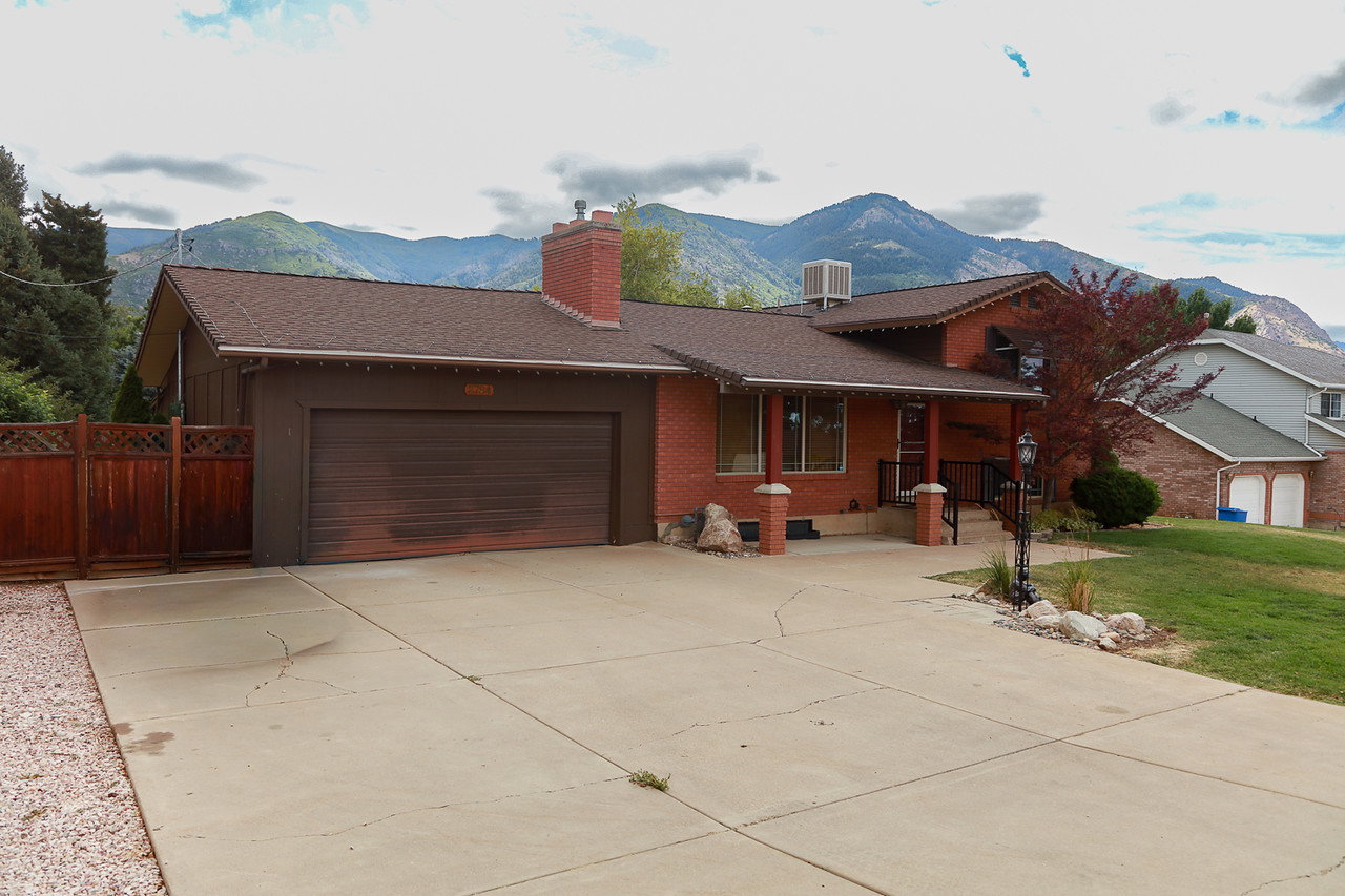 Brick exterior with a covered porch entry, a single-car garage, and a concrete driveway