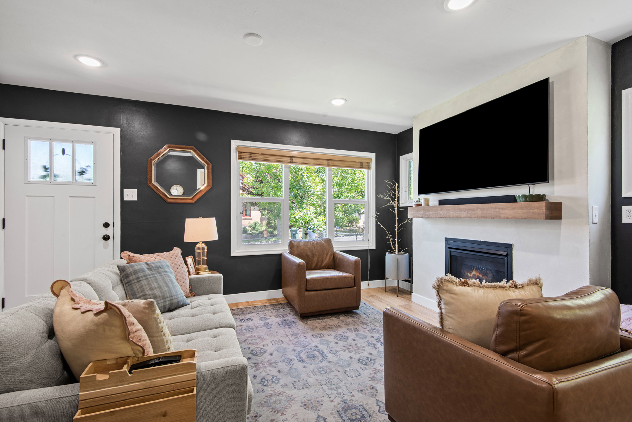 Living area featuring a white entry door with clear glass inserts, recessed lighting, and wood-finish flooring