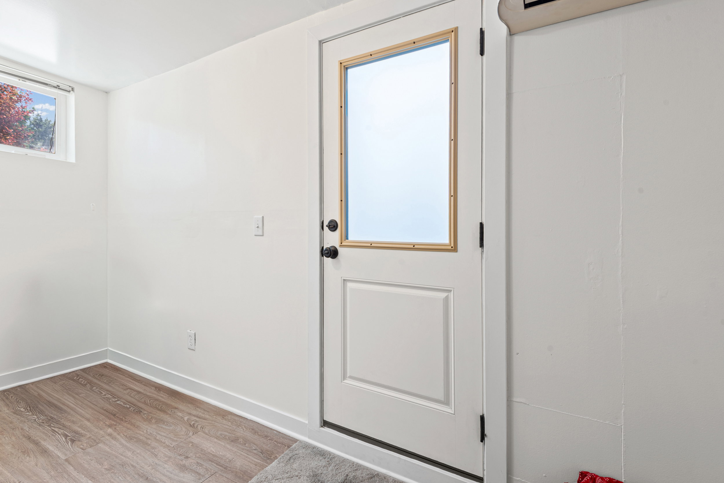 White paneled door with a frosted glass insert and dark hardware