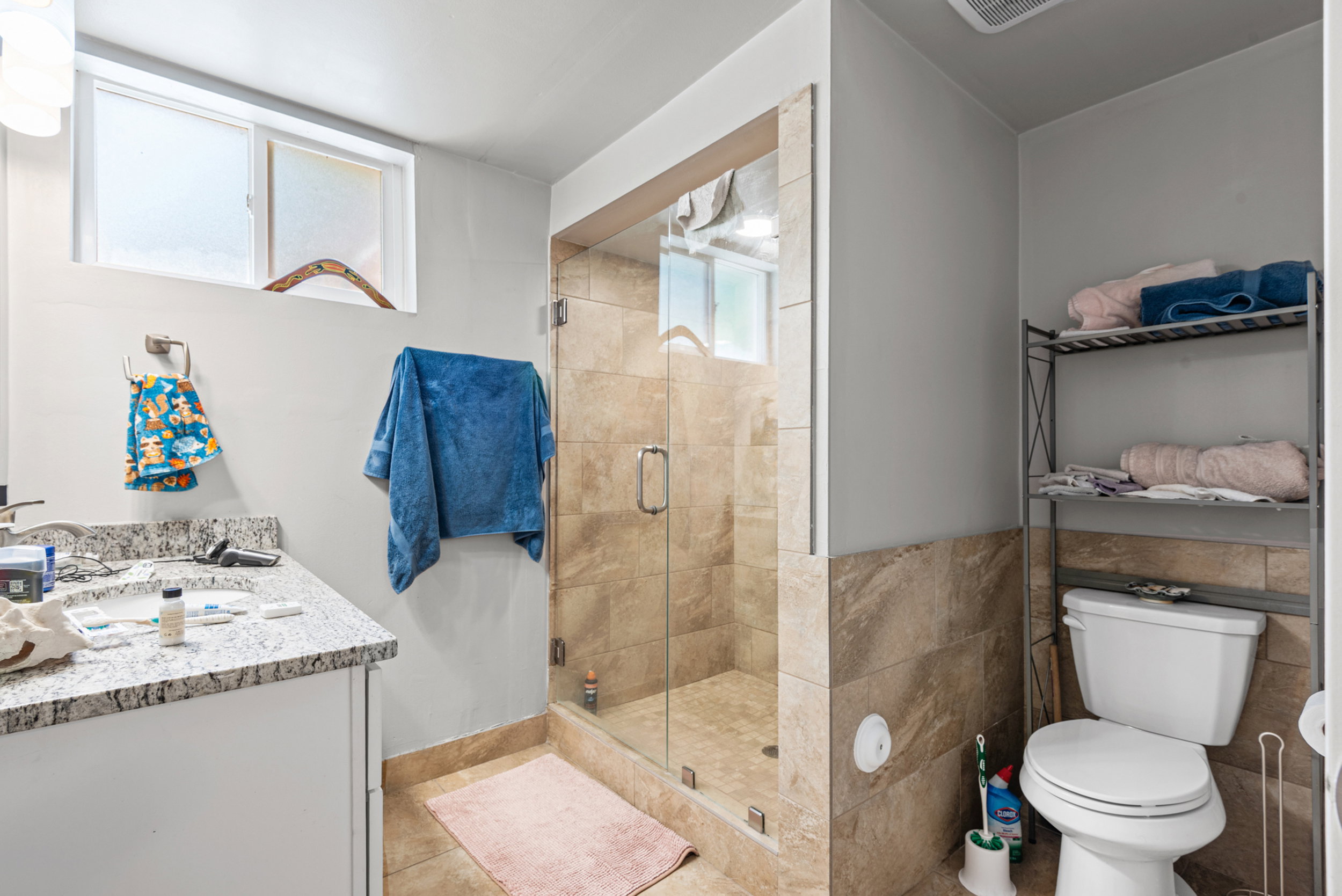 Enclosed shower with glass door and full tile surround