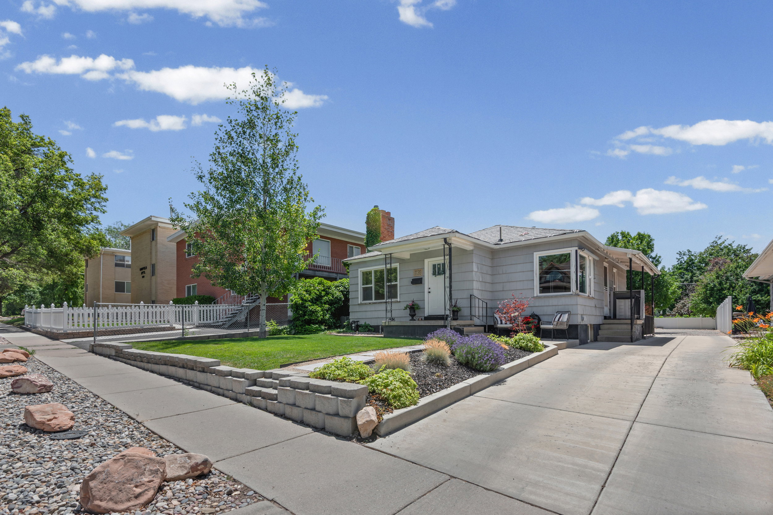 Light gray siding exterior with a dark gray shingle roof