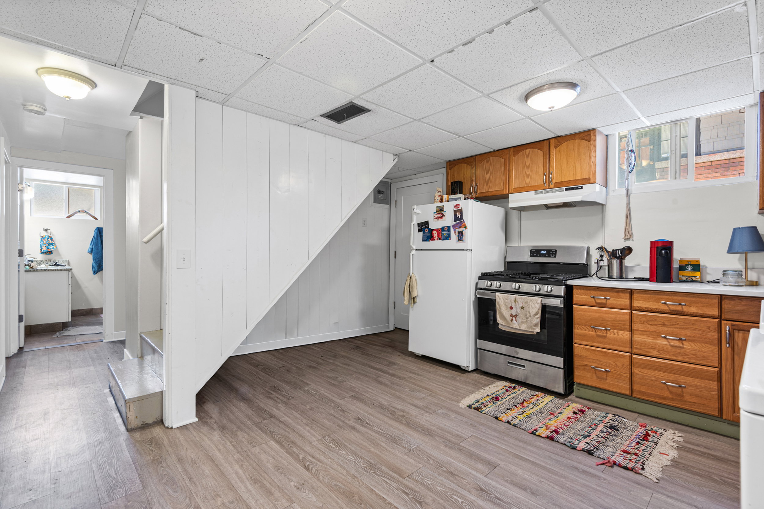 Kitchen area featuring wood-finish flooring, wood cabinetry, and stainless steel appliances