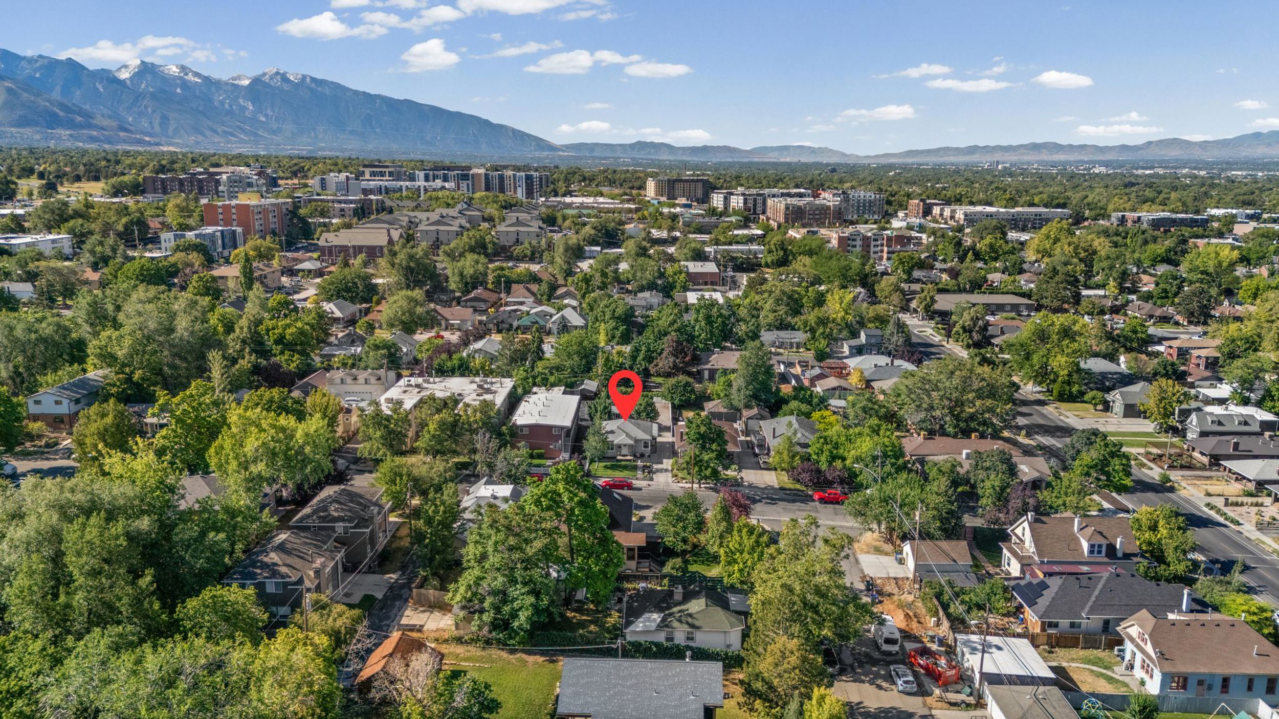 Neighborhood setting featuring mature tree canopies and varied architectural styles