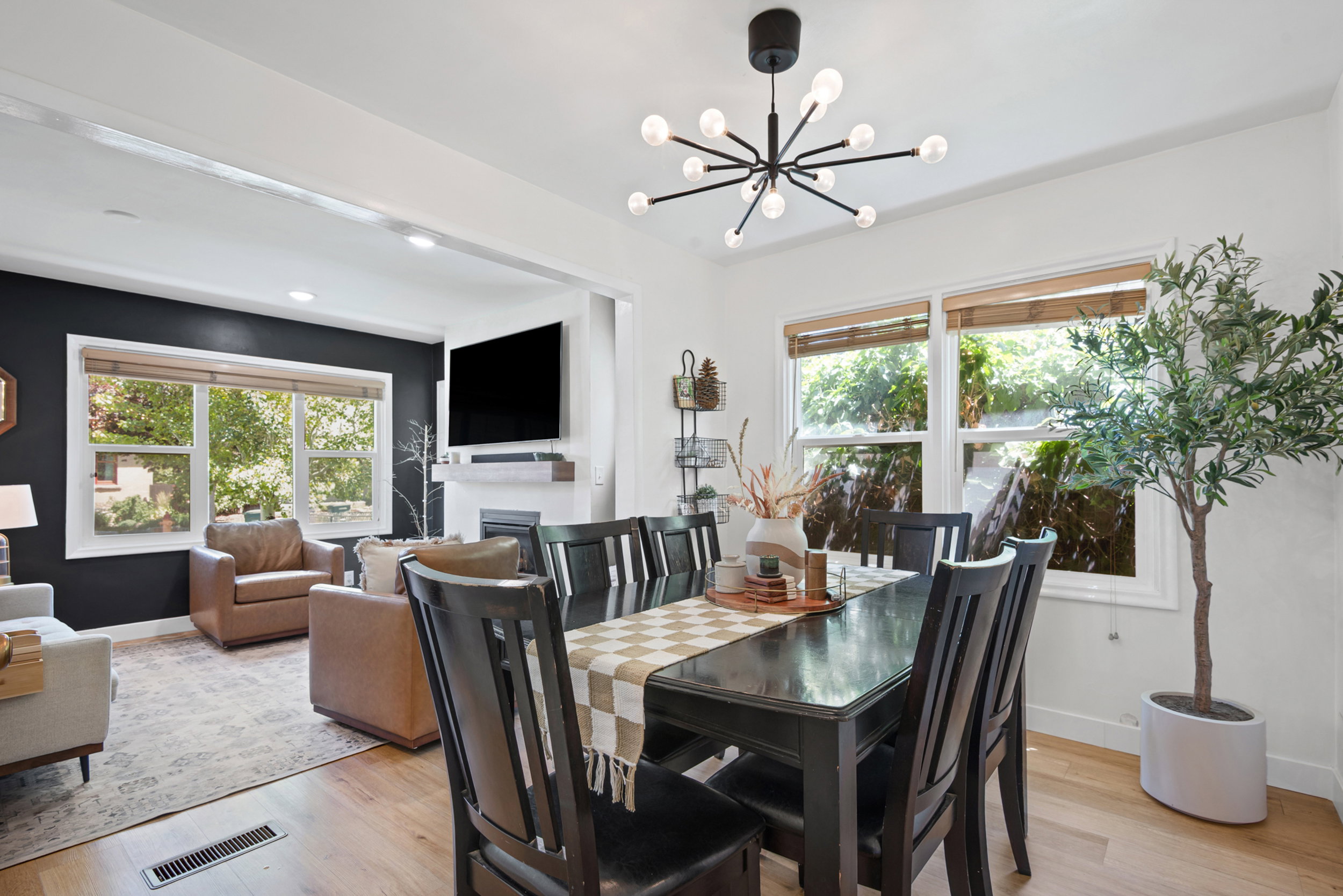 Formal dining area featuring a modern sputnik chandelier and wood-finish flooring
