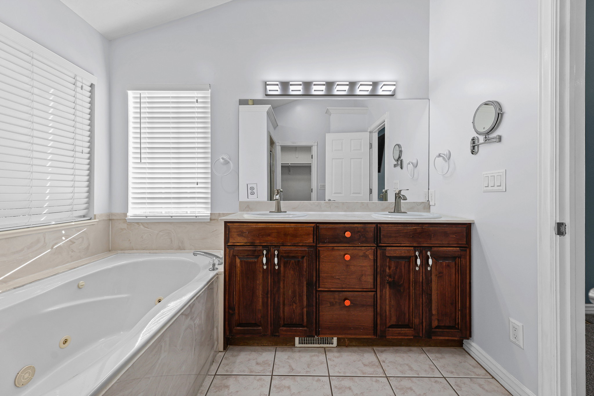 Dual vanity with integrated sinks and a large mirror, set against a light-toned countertop
