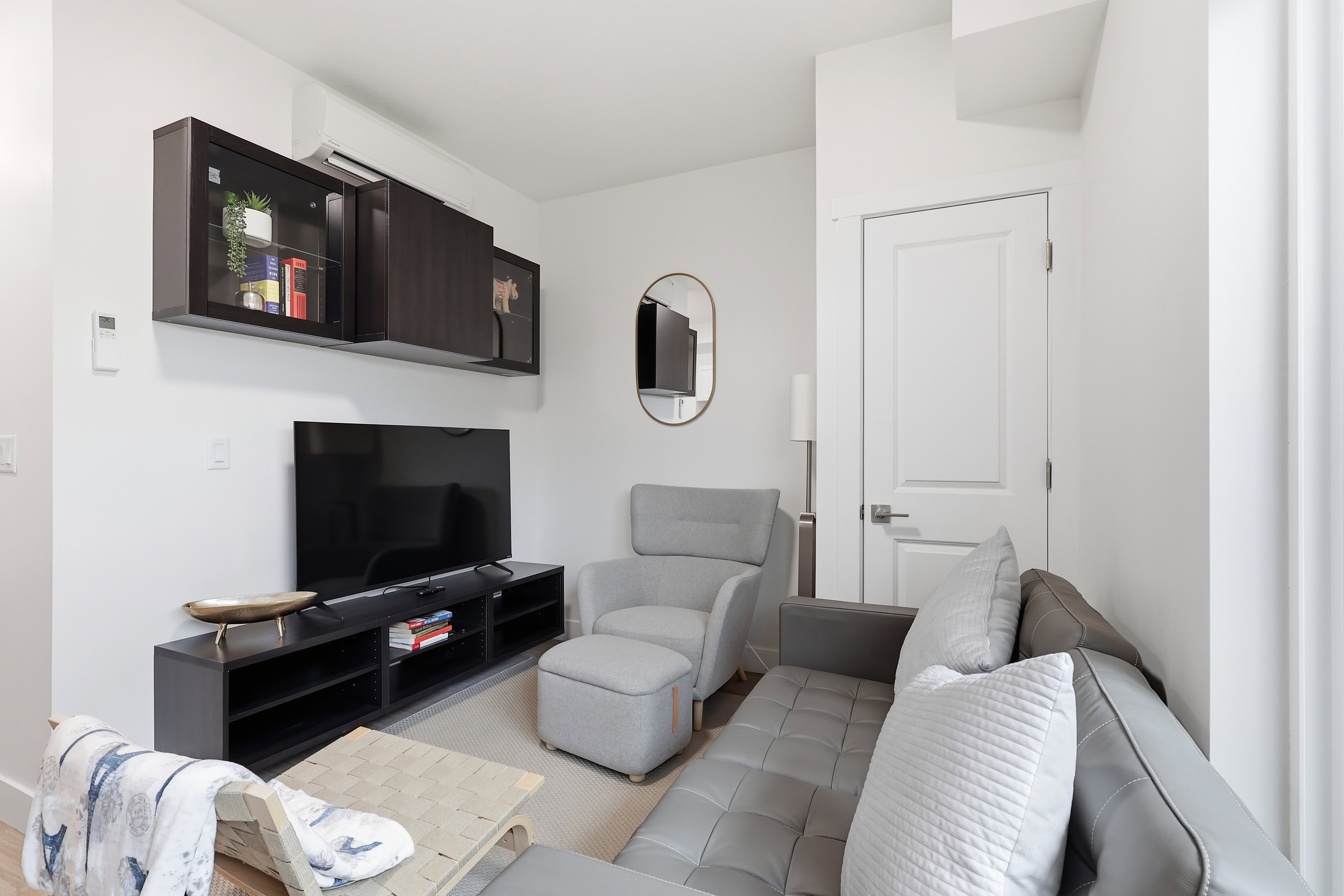 Living area with white walls and light-colored flooring
