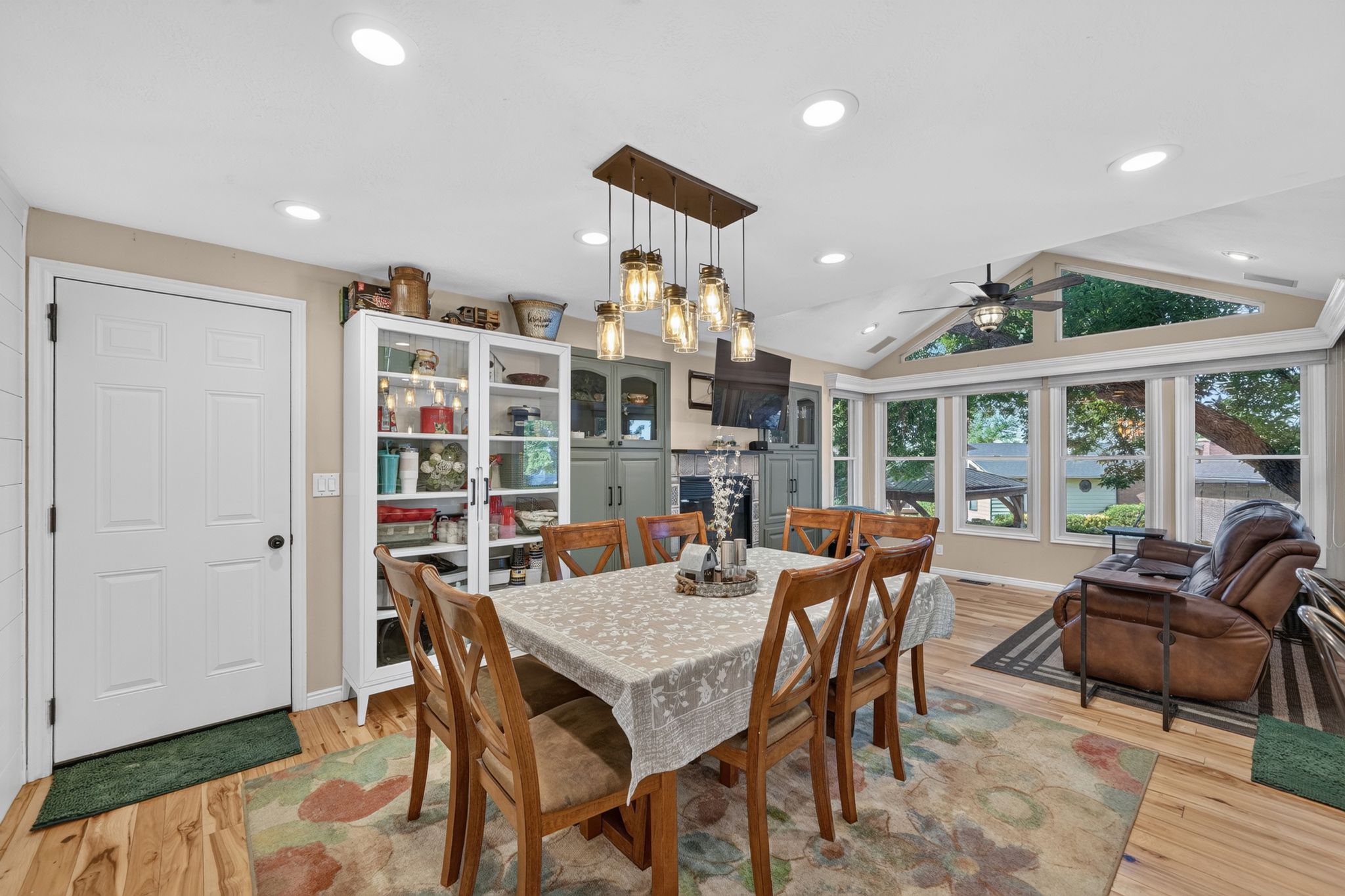 Dining area featuring wood-finish flooring and a rectangular chandelier with Edison-style bulbs