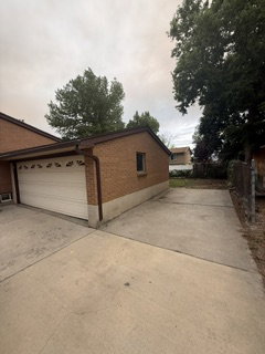 Brick exterior with an attached garage and concrete driveway