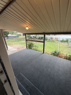 Covered patio area featuring a beige paneled ceiling and a built-in light fixture