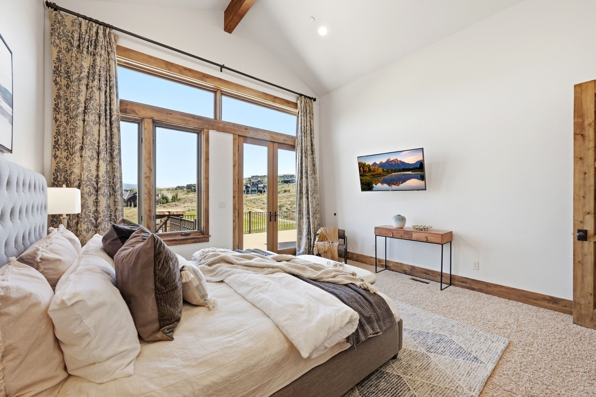 Expansive windows and French doors with rustic wood framing