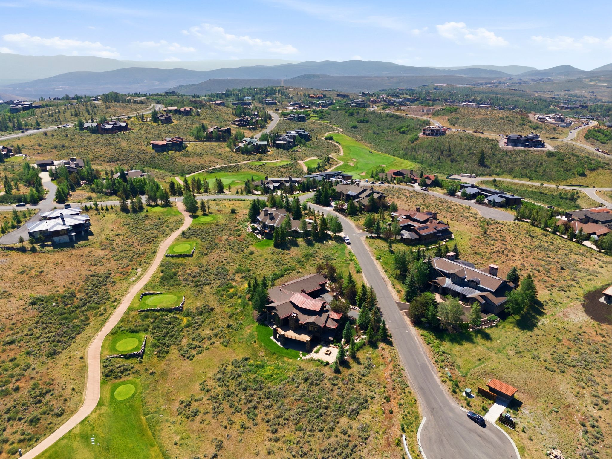 Expansive residential development featuring multiple custom homes situated on rolling terrain