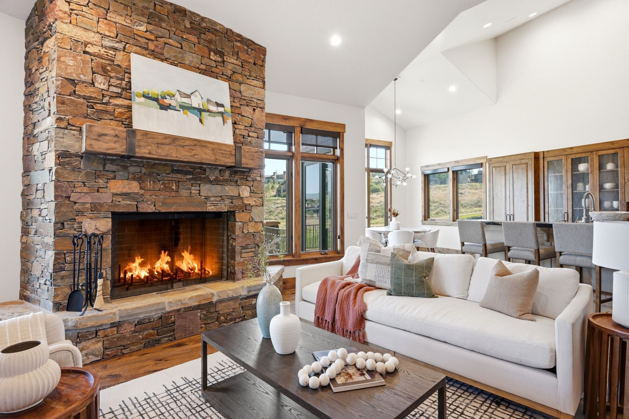 Stone-clad fireplace with a substantial timber mantle