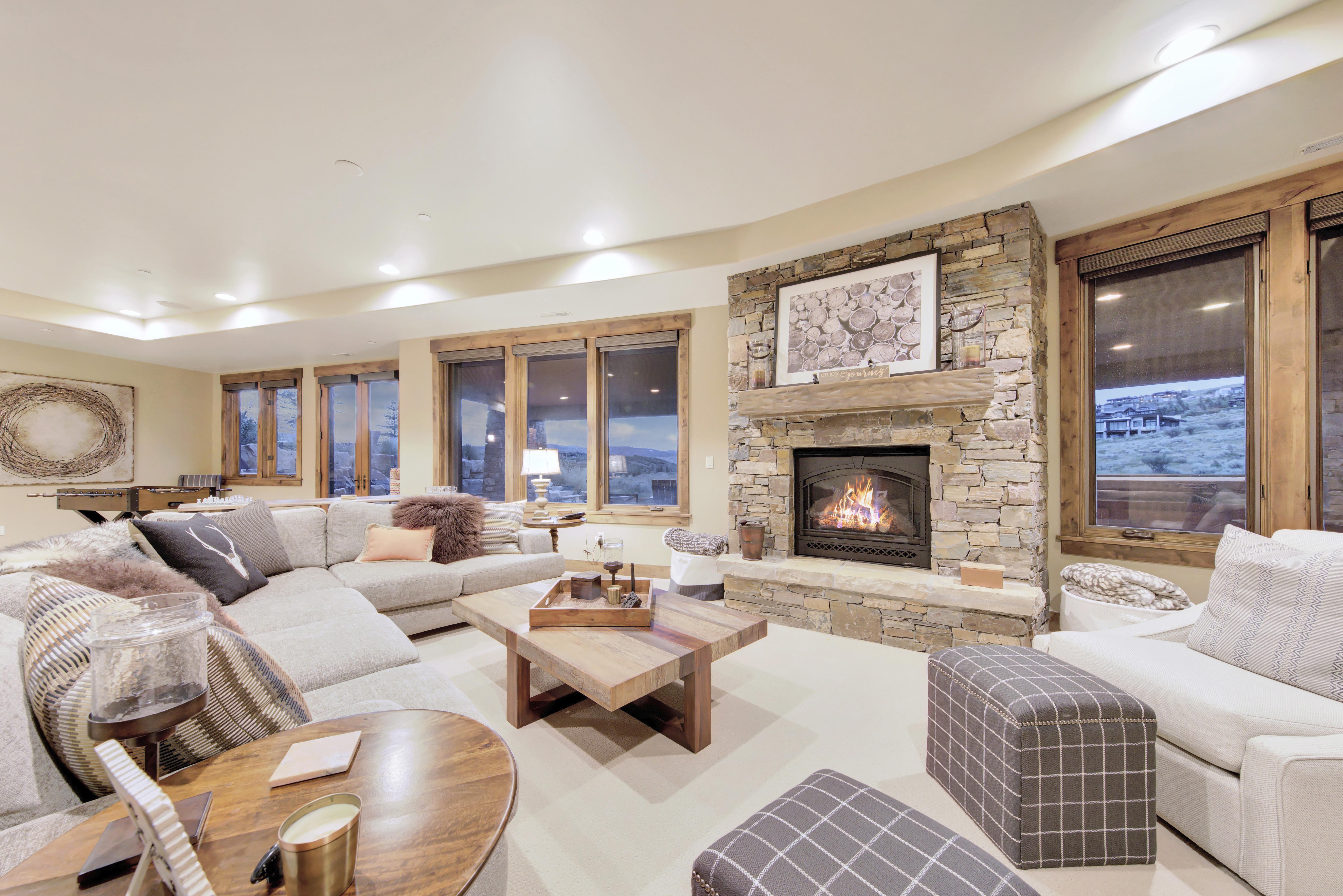 Living area featuring a stone-clad fireplace with a wood mantel