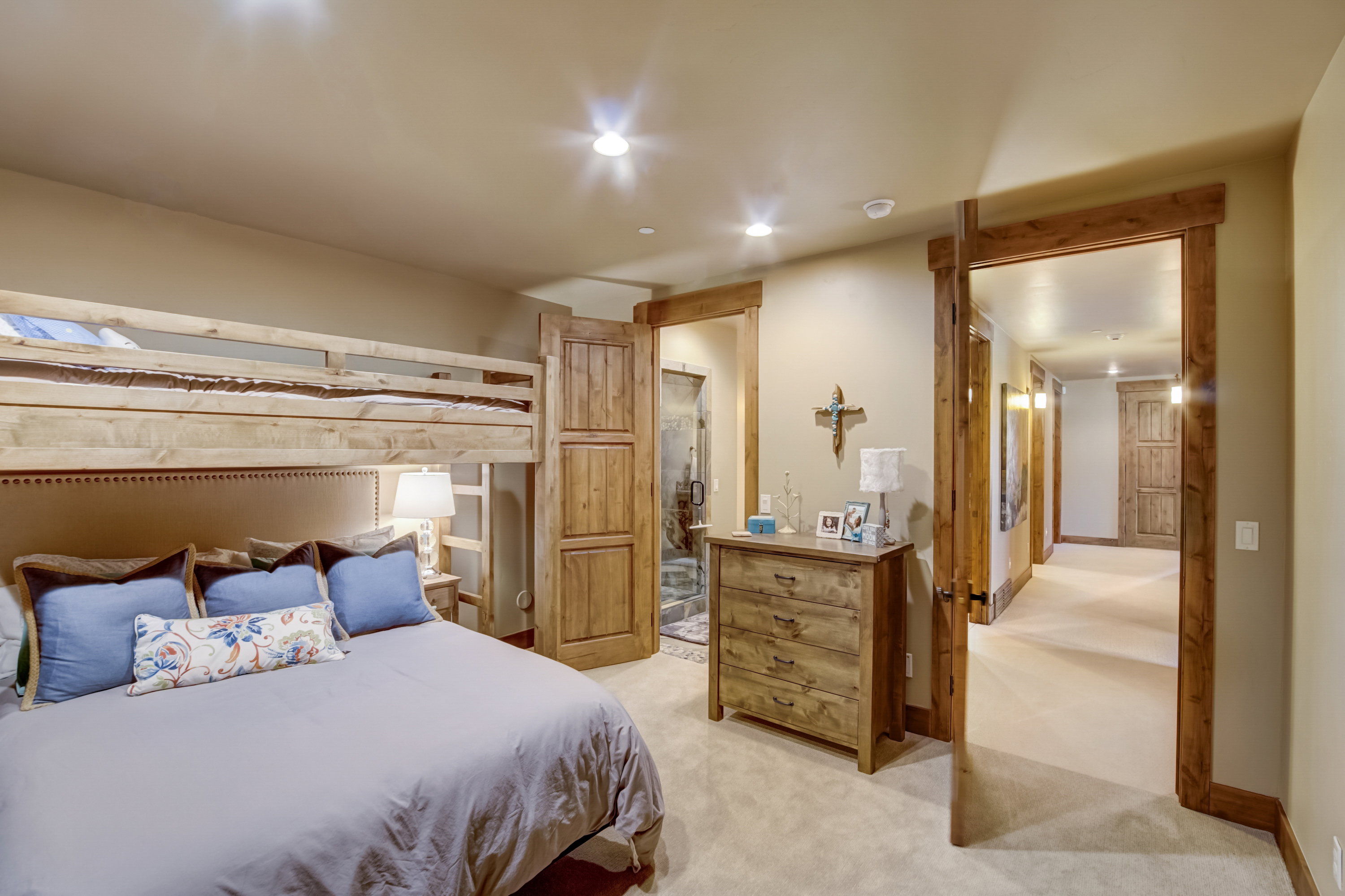 Bedroom featuring a built-in bunk bed, a wood-finish dresser, and wood-finish door frames