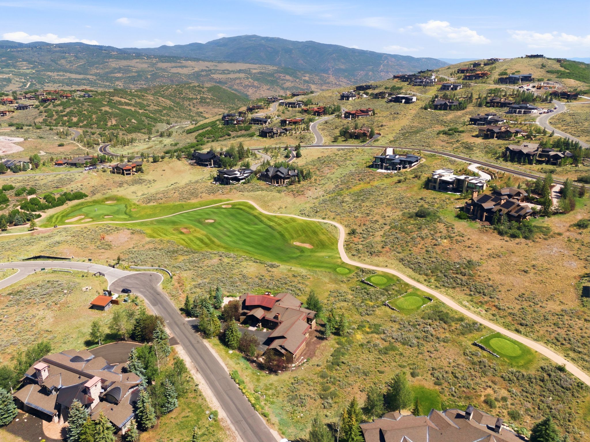 Expansive golf course community with rolling hills and distant mountains