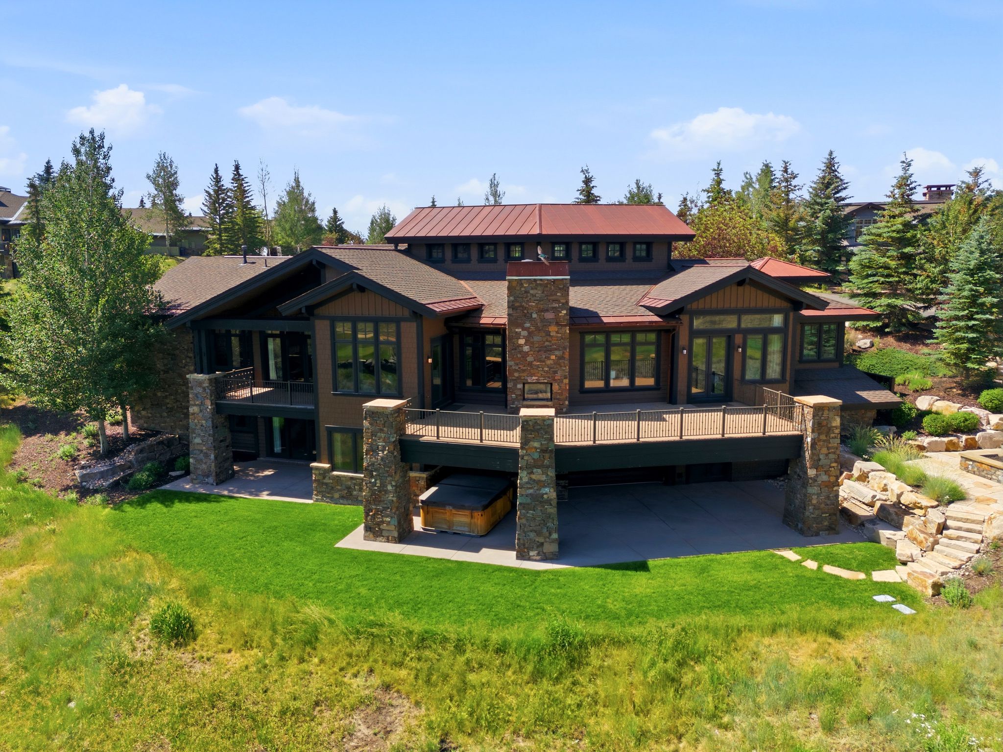 Contemporary mountain-style architecture featuring extensive stonework and wood siding