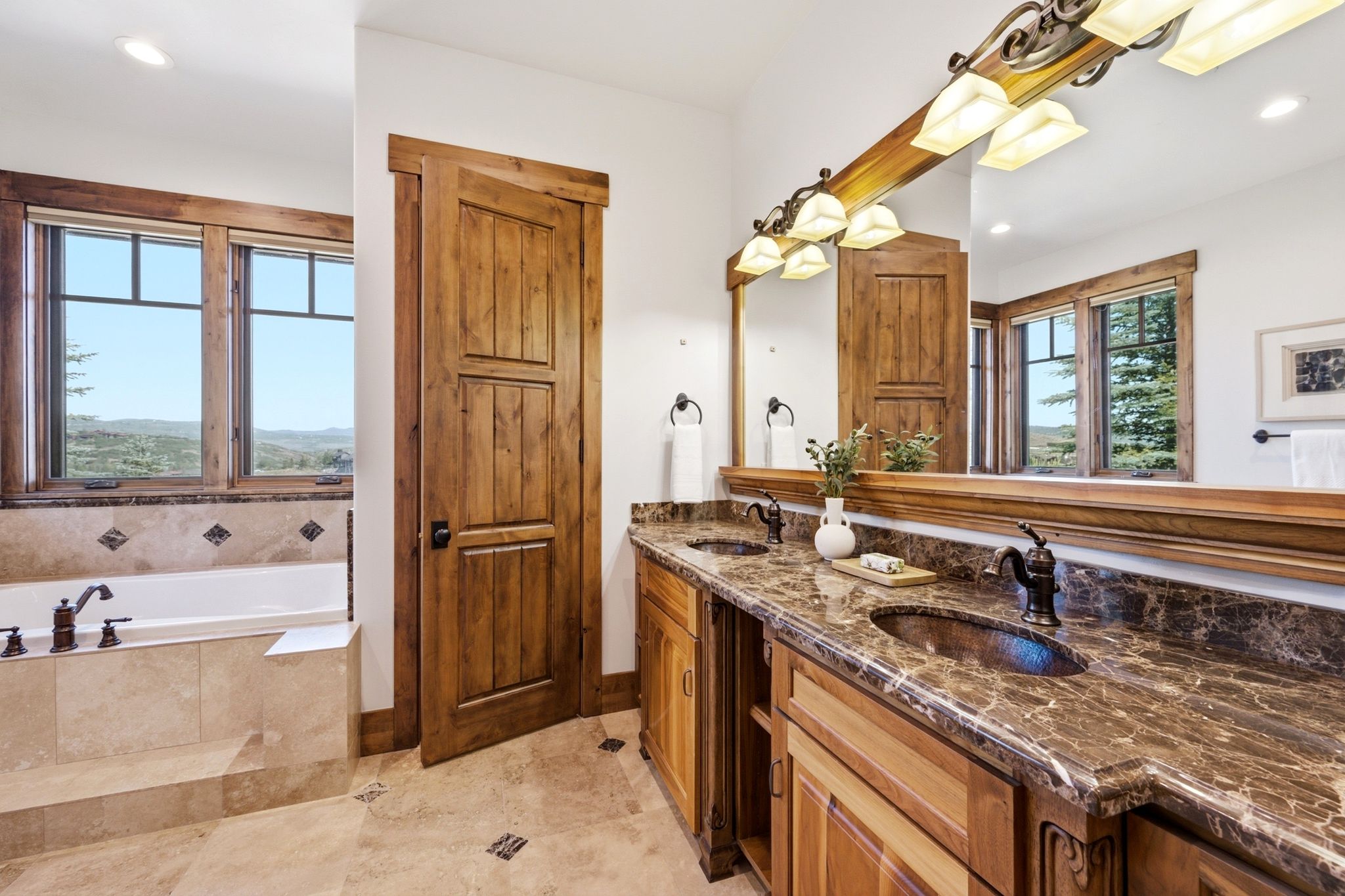 Dual vanity with dark stone countertops and integrated sinks