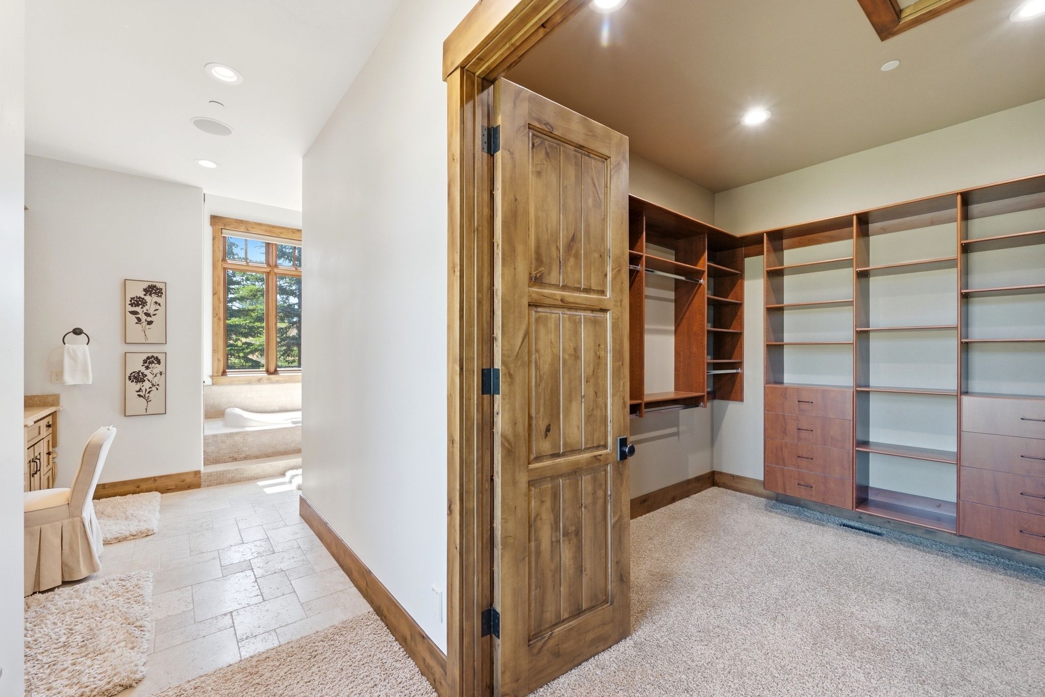 Spacious walk-in closet with extensive built-in shelving and drawer storage