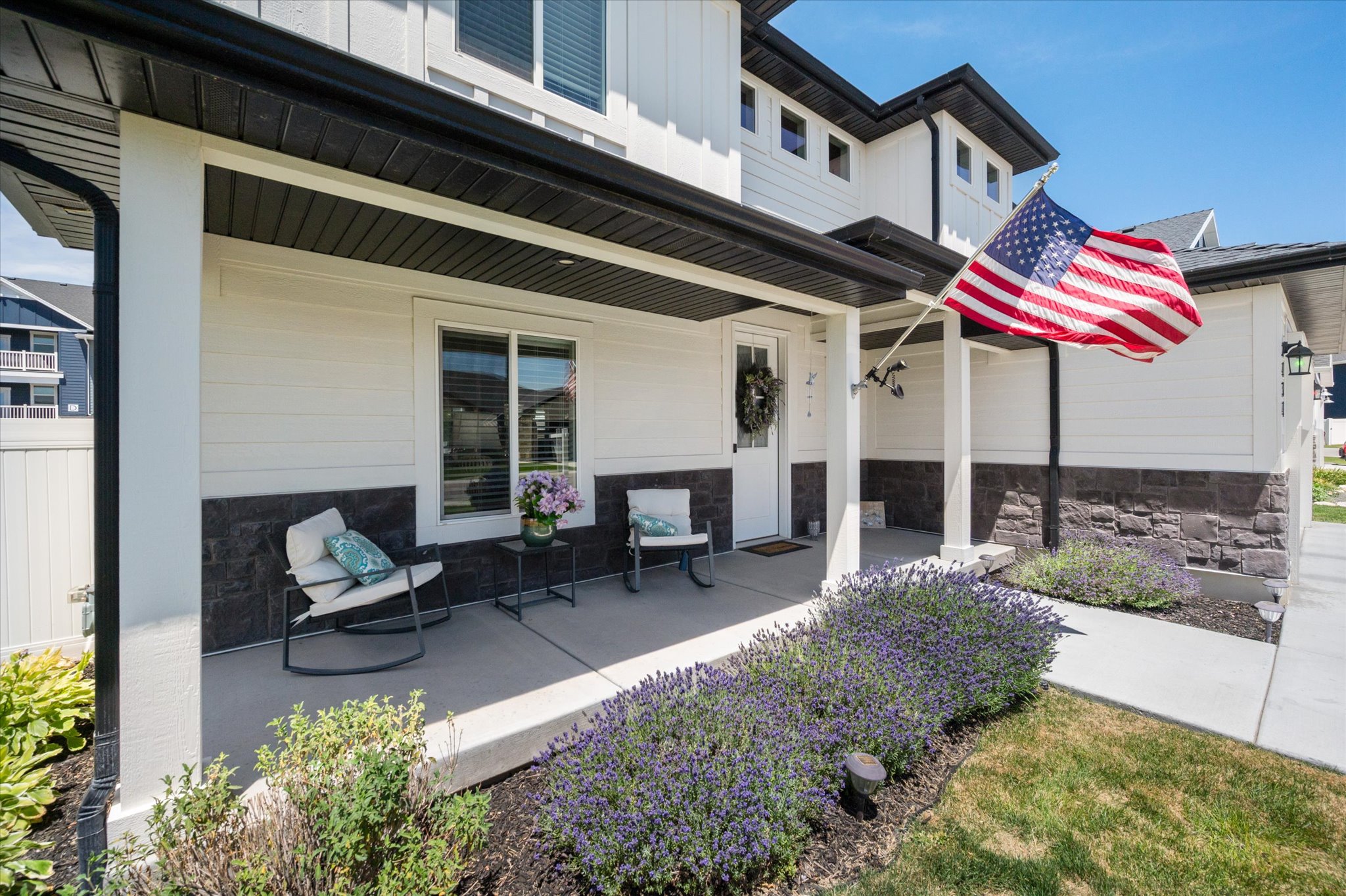 Inviting covered porch with concrete flooring and white columns