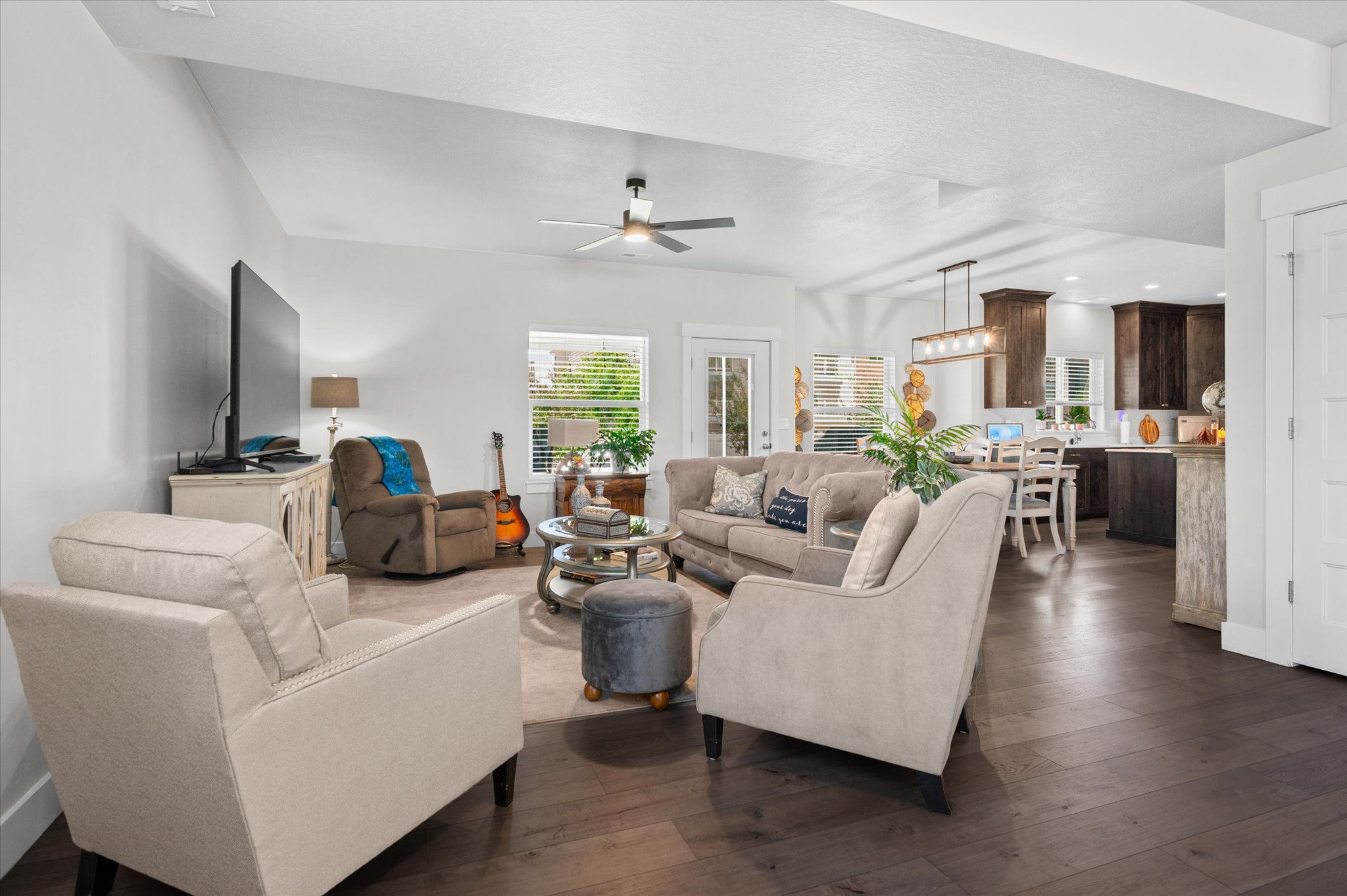 Open-concept living space featuring wood-finish flooring and recessed lighting