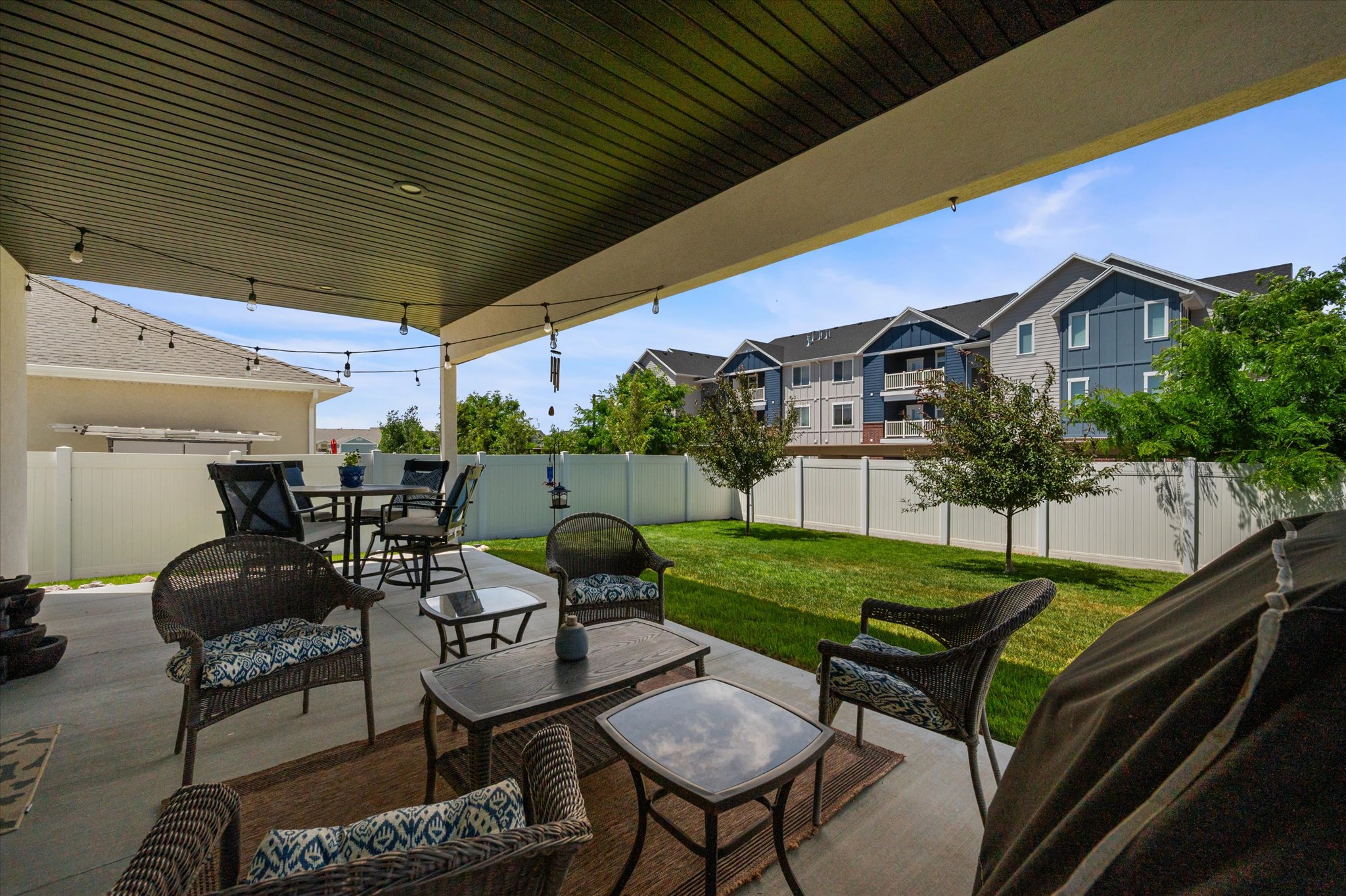 Covered patio with string lighting and a concrete surface