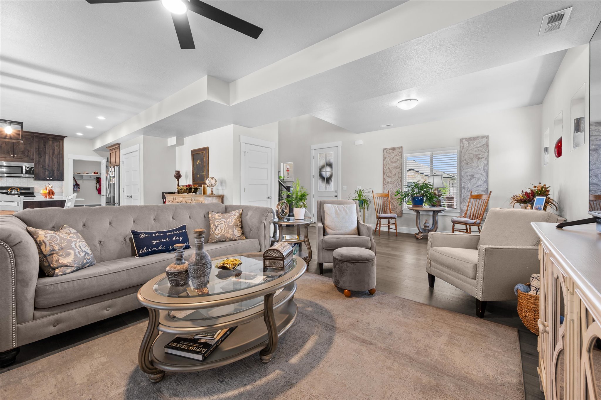 Spacious living area featuring wood-finish flooring, recessed lighting, and a ceiling fan