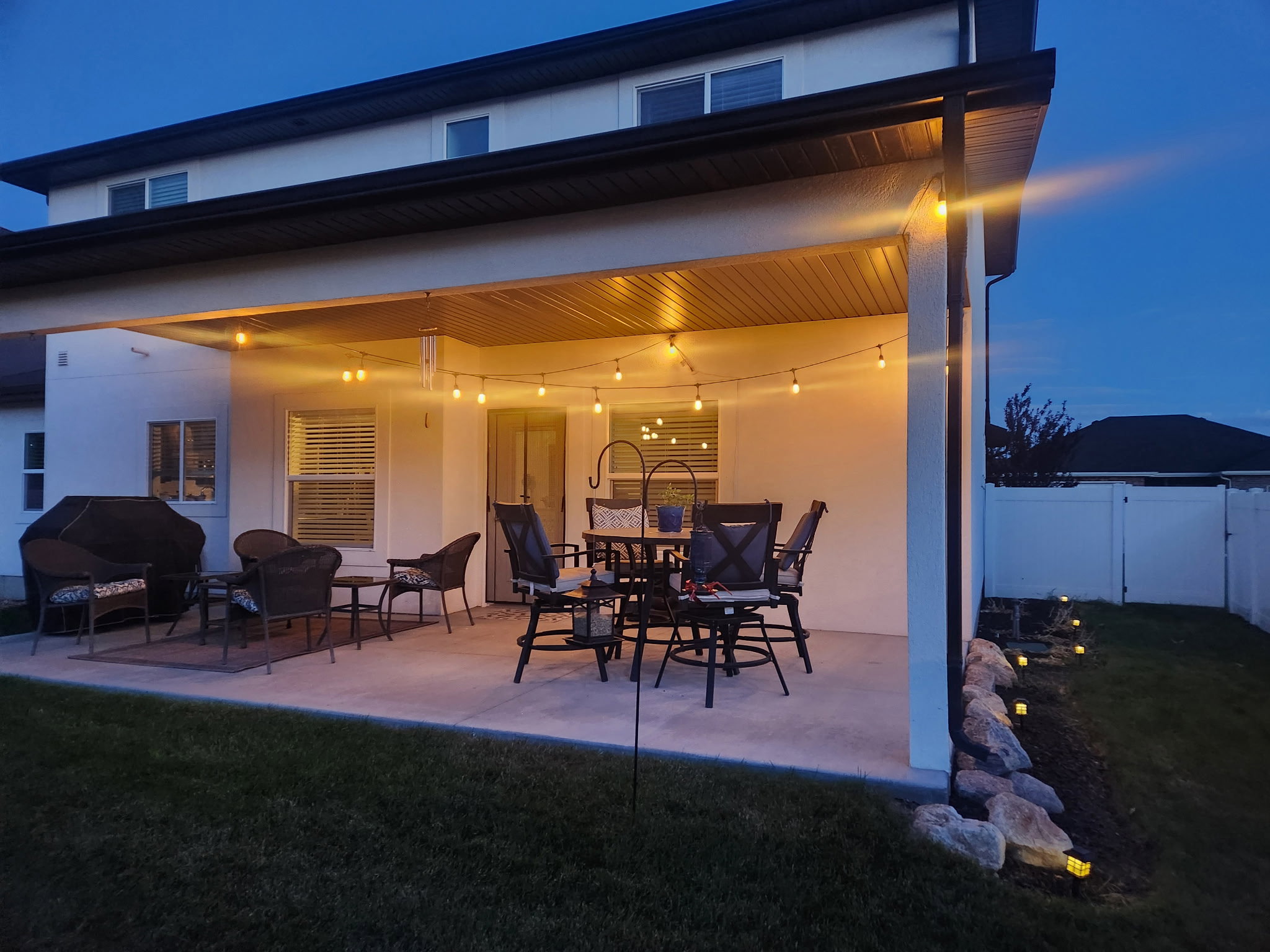 Expansive covered patio featuring a concrete surface and string lighting