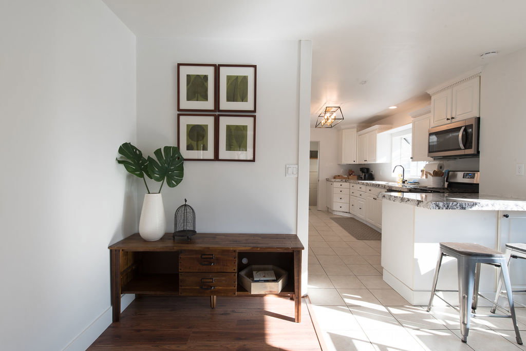 Kitchen featuring white cabinetry, stainless steel appliances, and a light-toned tile floor