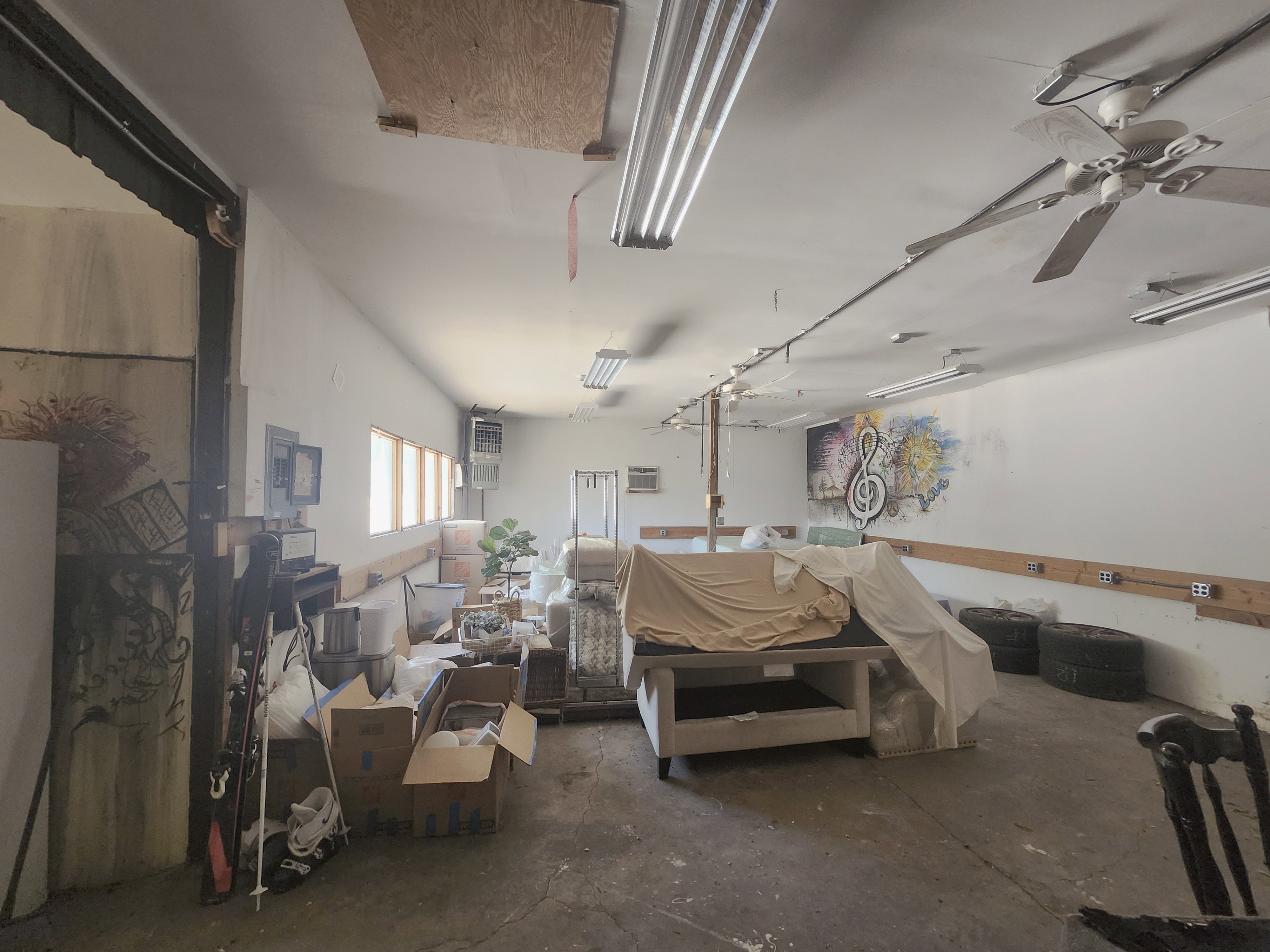 Spacious interior with concrete flooring and exposed ceiling beams