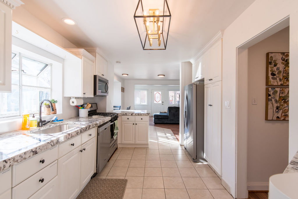 Bright kitchen with white cabinetry and light-toned countertops