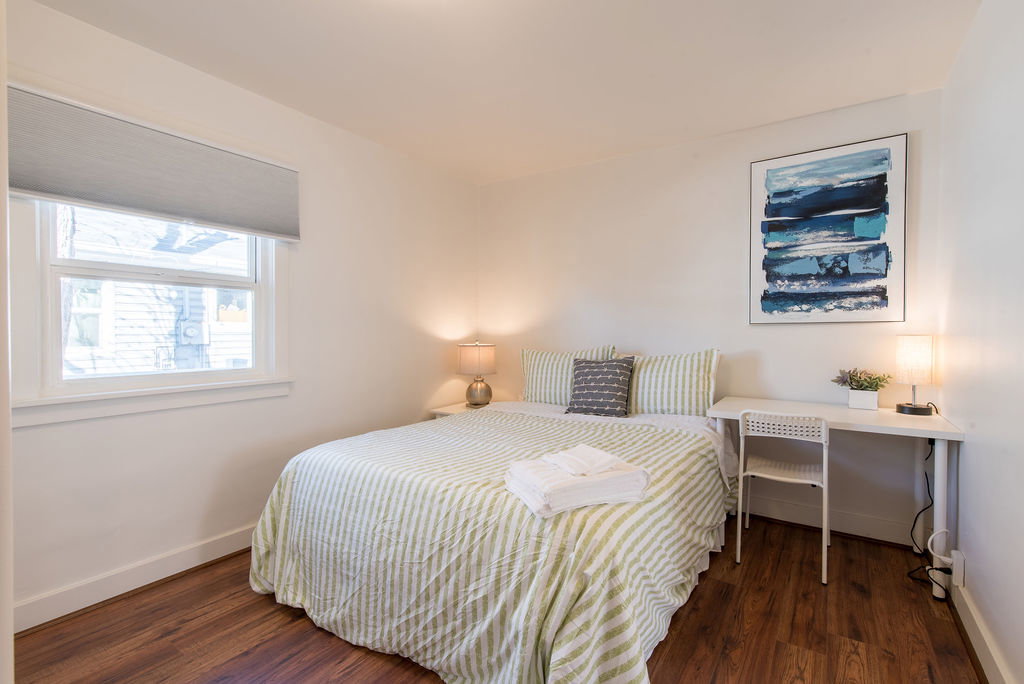 Bright interior room featuring wood-finish flooring and white baseboards