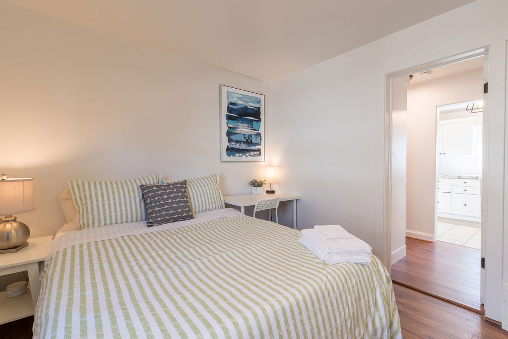 Bedroom featuring wood-finish flooring and neutral wall tones