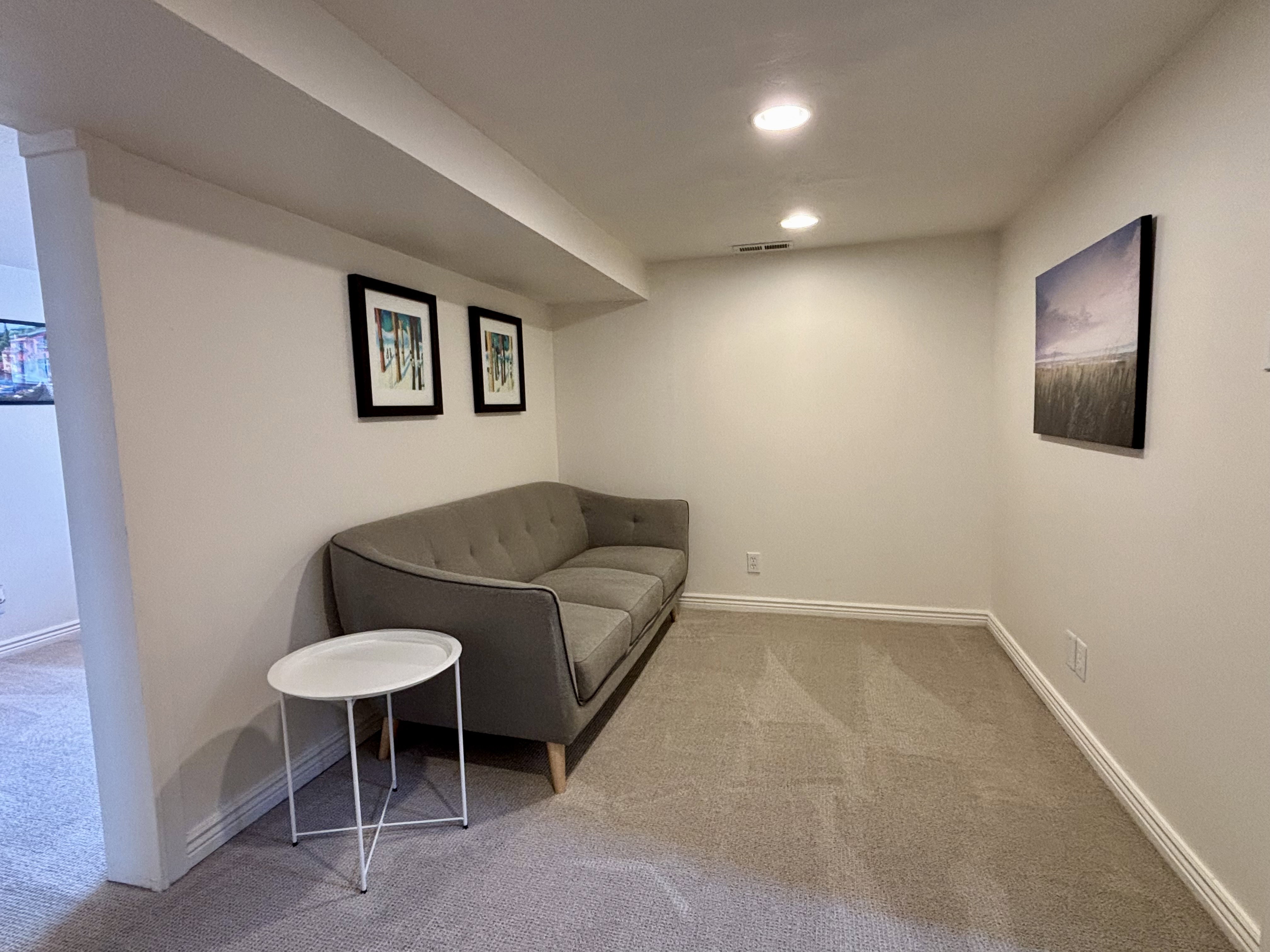 Carpeted interior space featuring recessed lighting, painted walls, and white baseboards