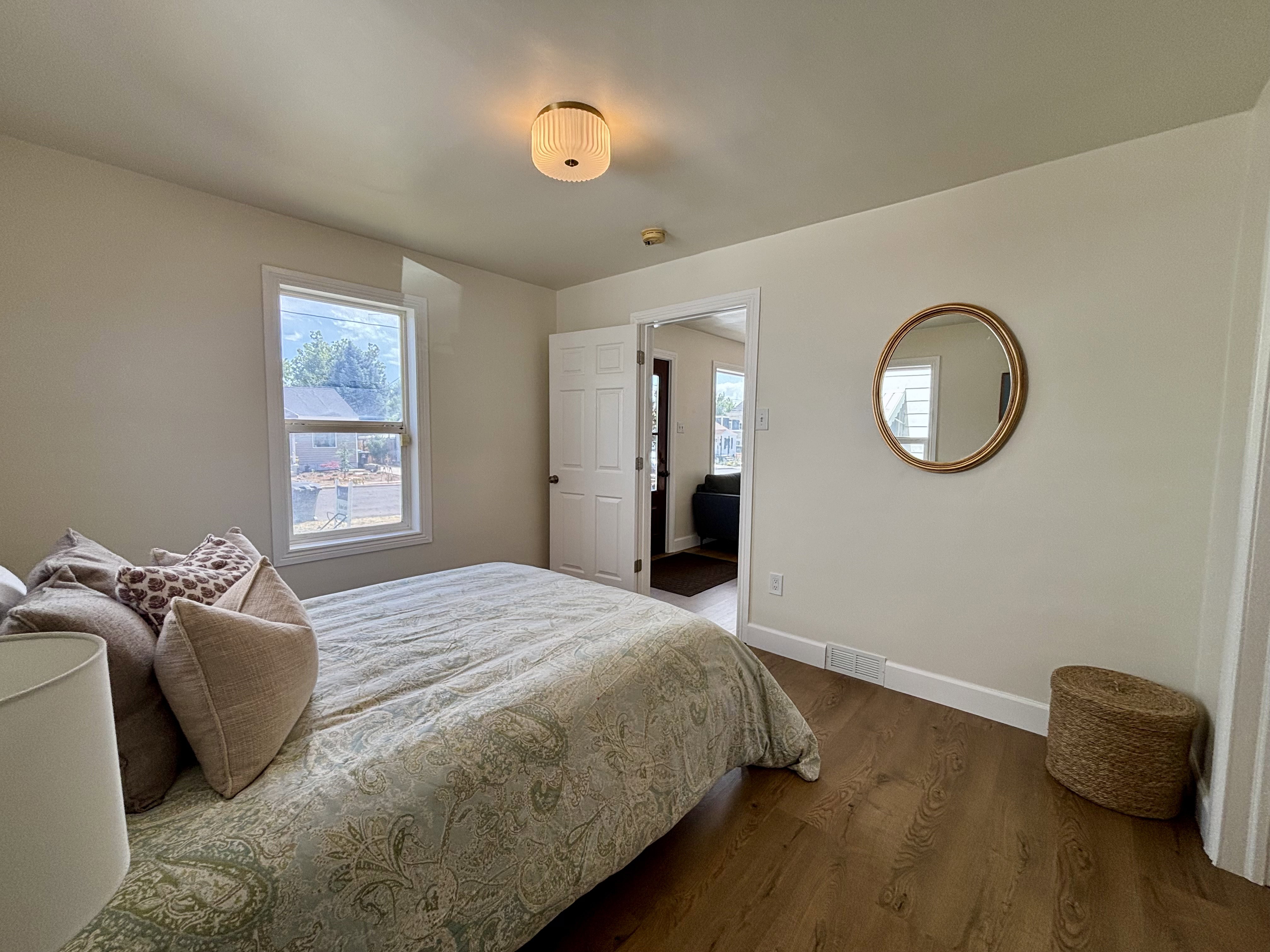 Room featuring wood-finish flooring, neutral wall paint, and white trim