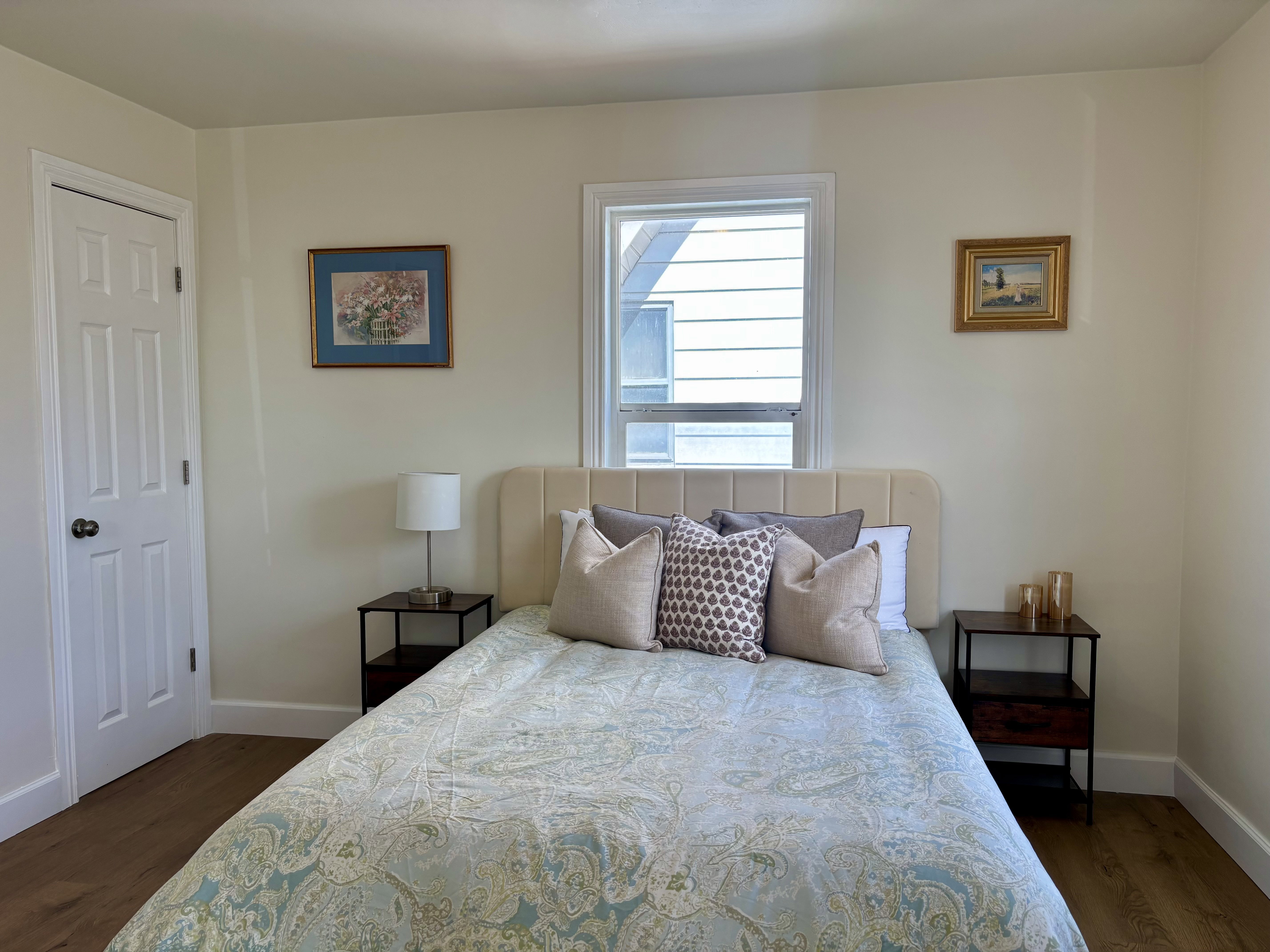 Bright room featuring light-toned walls and wood-finish flooring