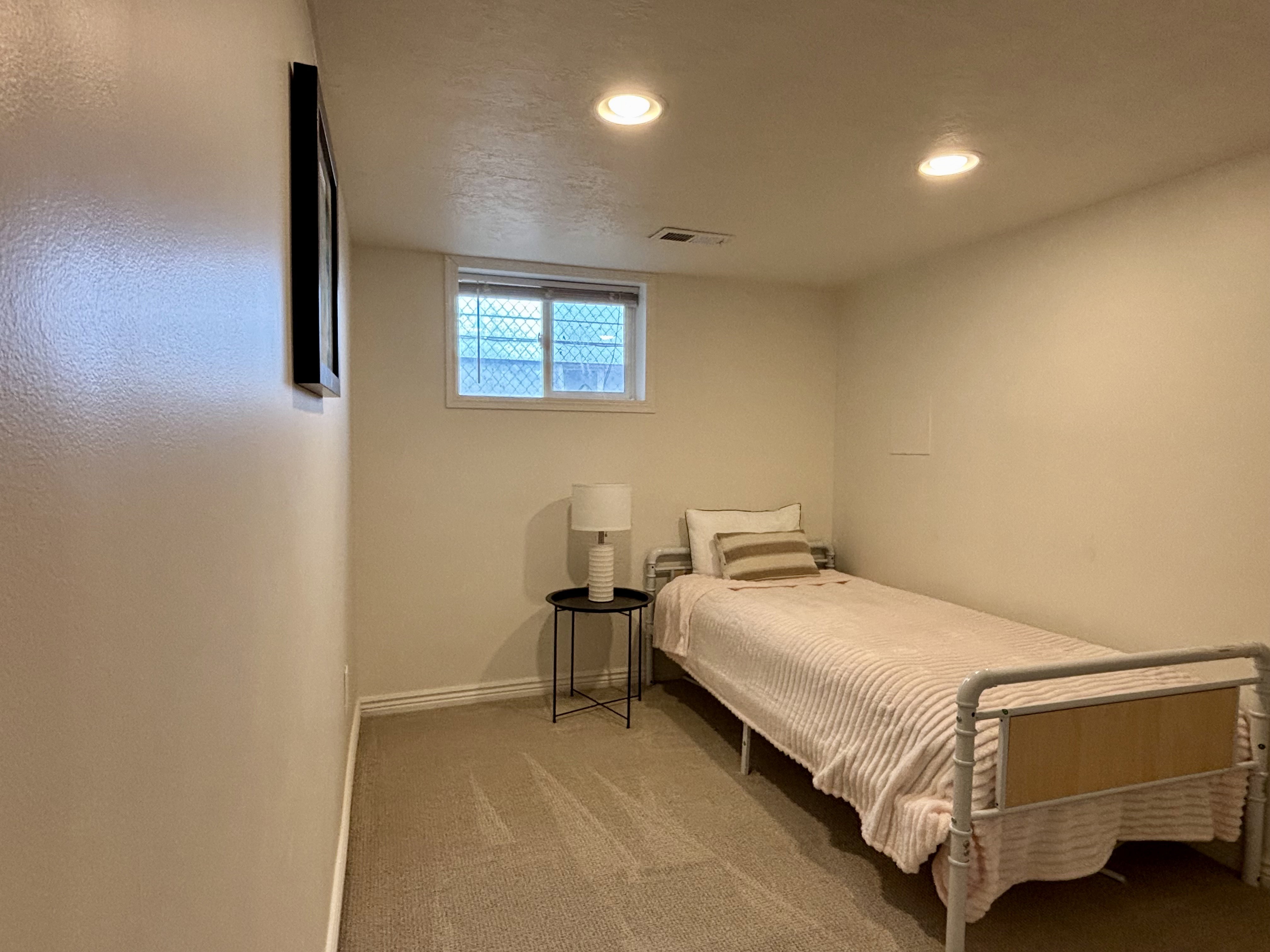 Carpeted room featuring a window with blinds, recessed ceiling lighting, and neutral wall finishes
