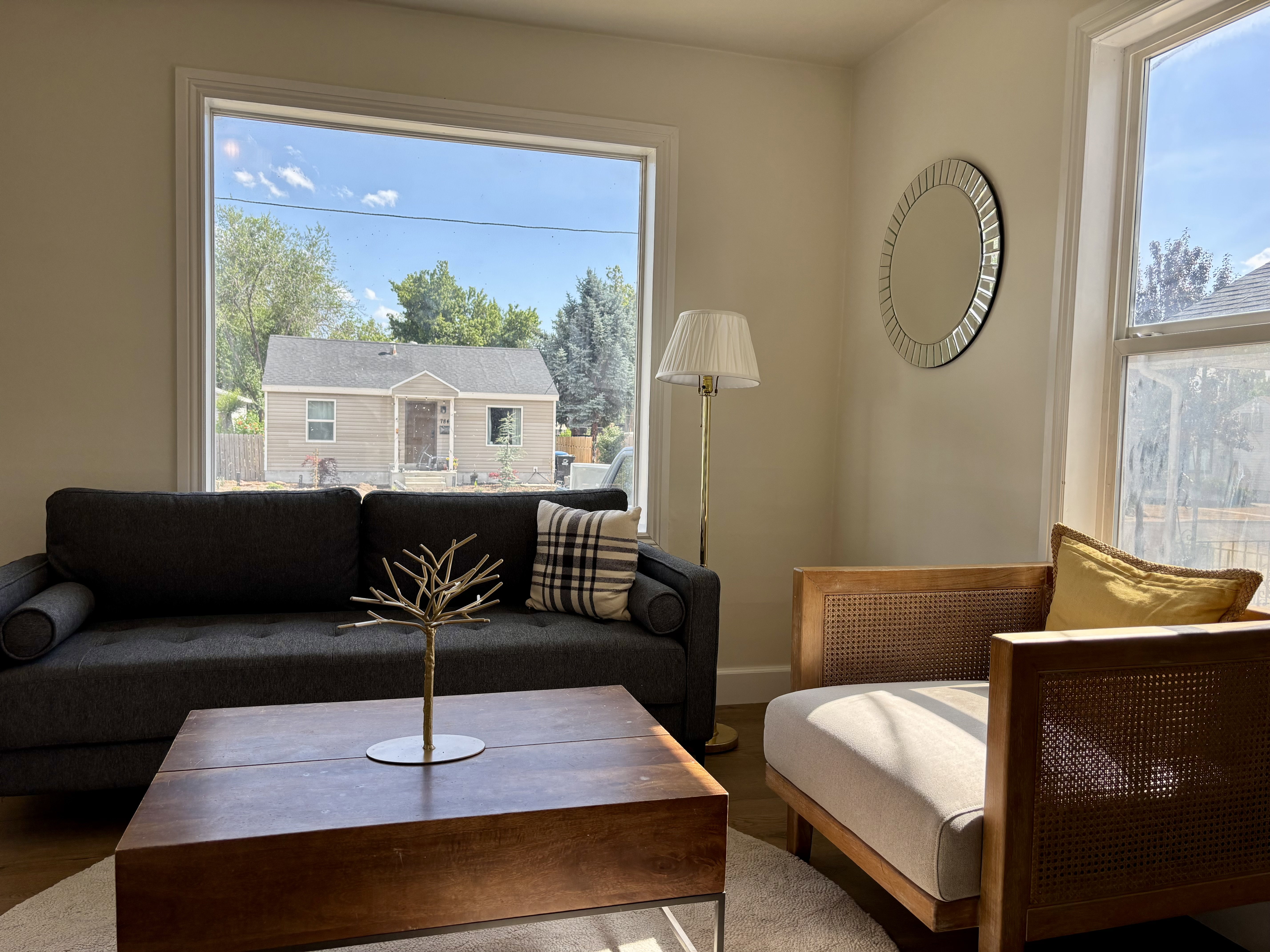 Spacious room featuring multiple windows with clean white trim, light-toned wall finishes, and wood-finish flooring