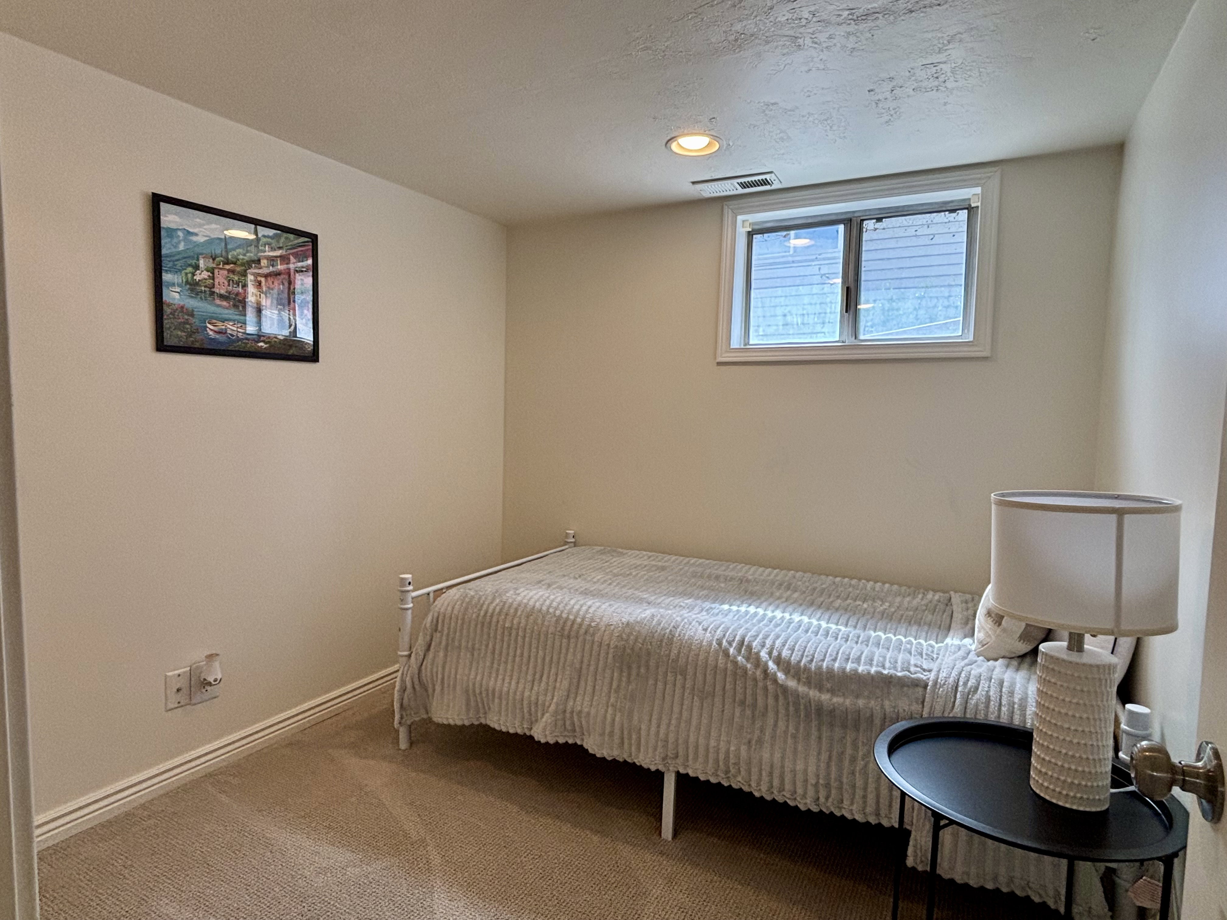 Carpeted room featuring a single window, white trim, recessed lighting, and neutral wall tones
