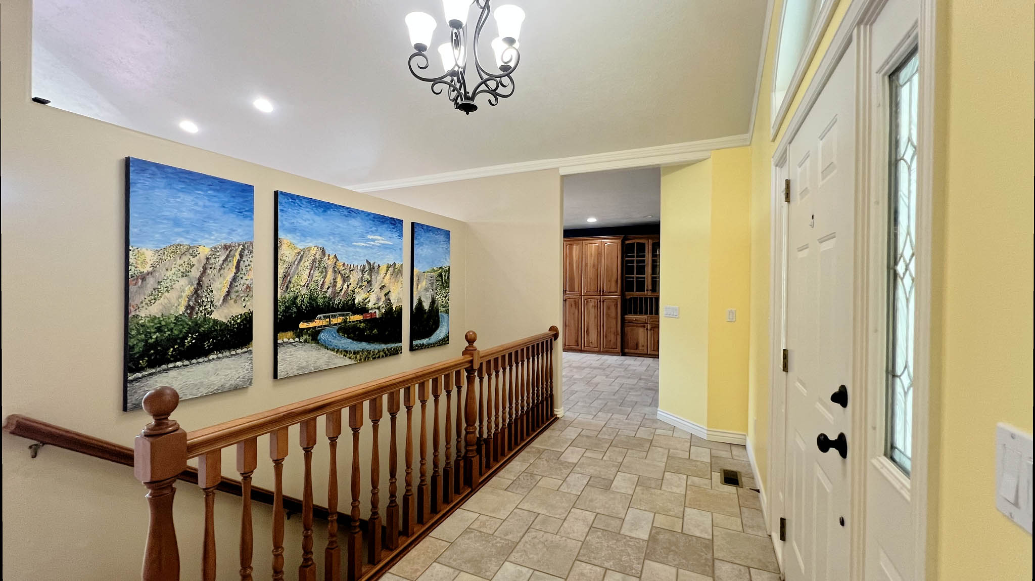 Entryway featuring neutral-toned tile flooring and a white paneled door with decorative glass inserts