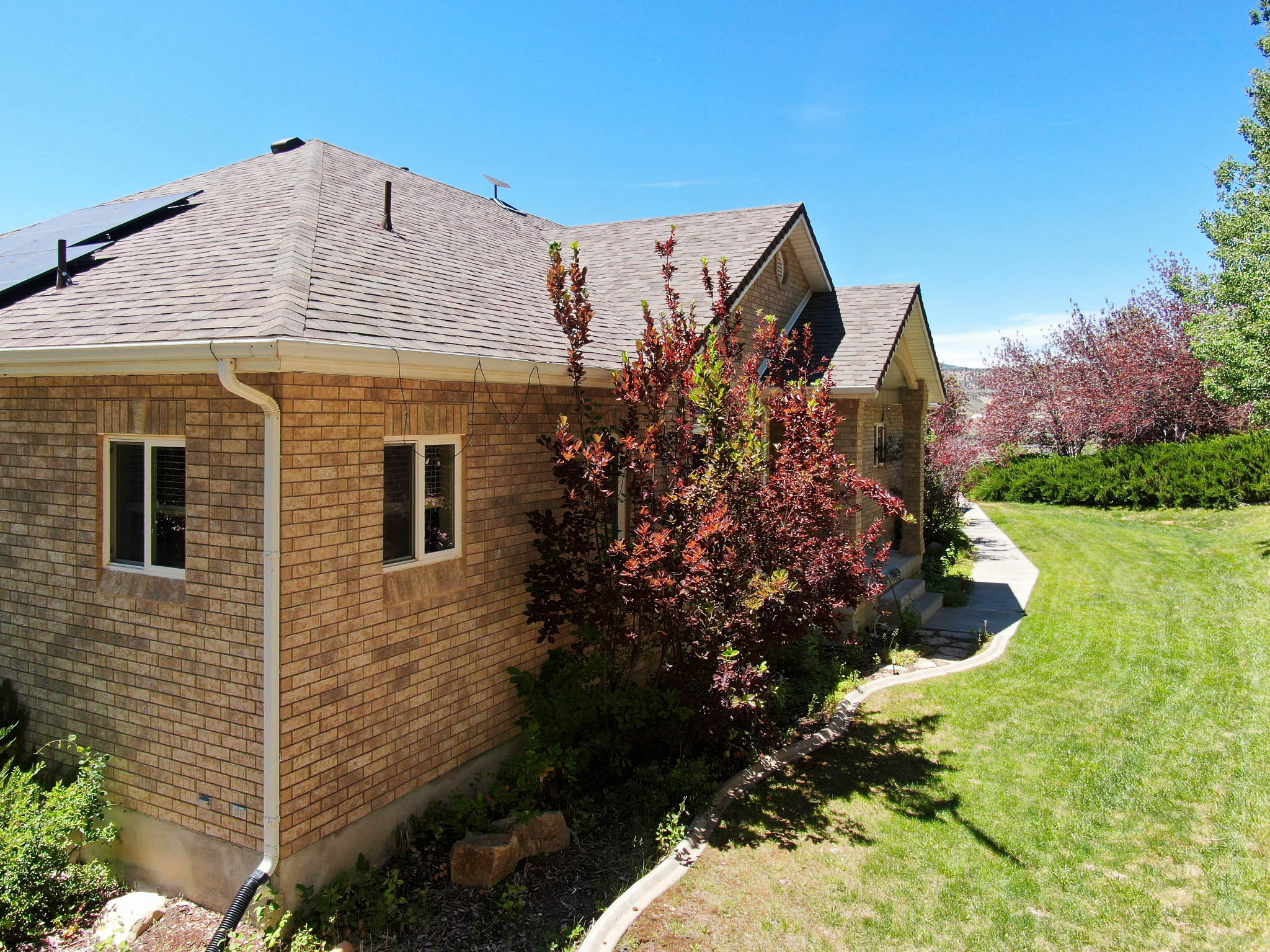 Brick exterior featuring a gabled roof and white-framed windows