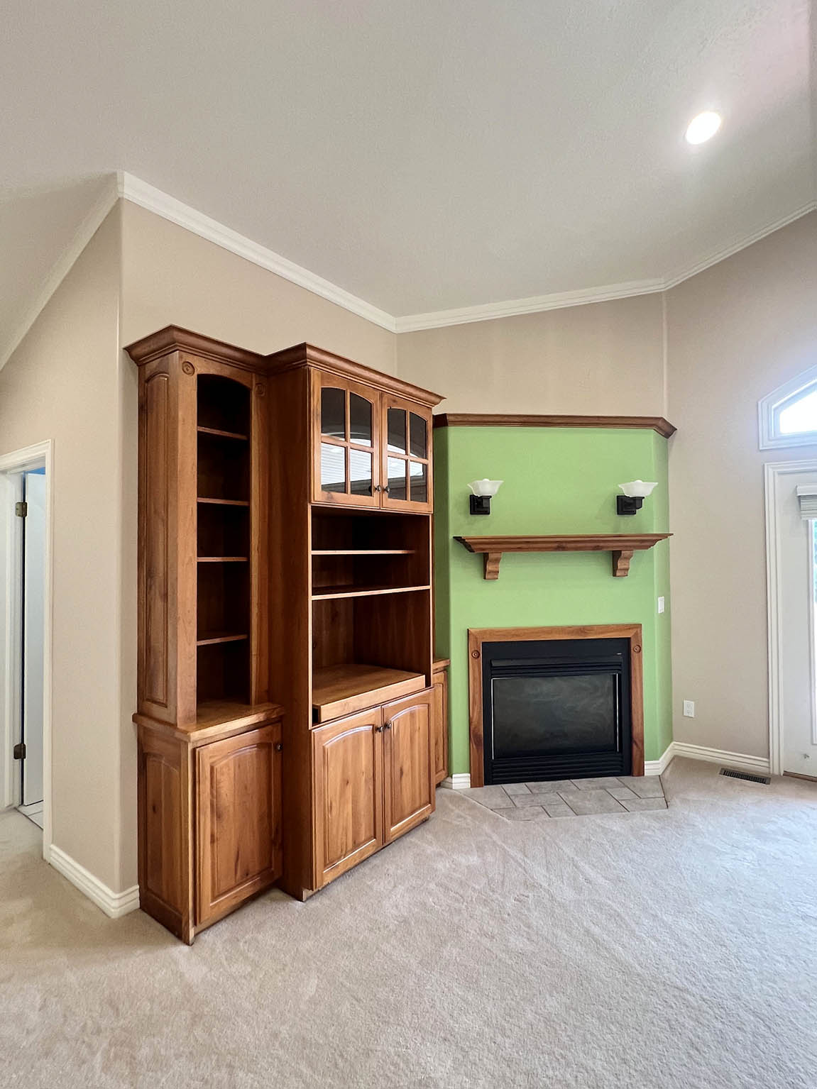 Integrated built-in cabinetry featuring glass-front doors and open shelving
