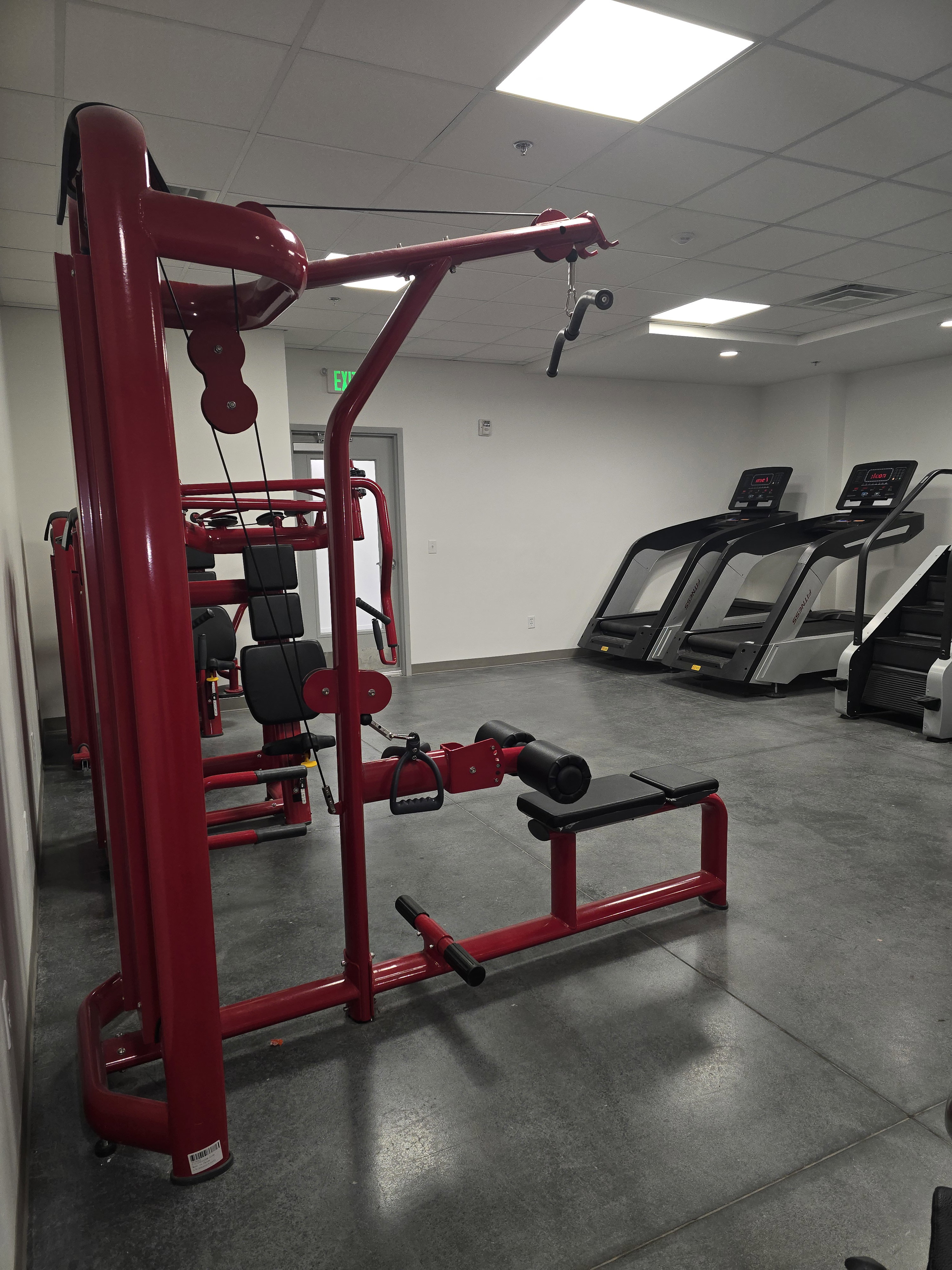 Fitness center featuring durable flooring, recessed lighting, and white walls