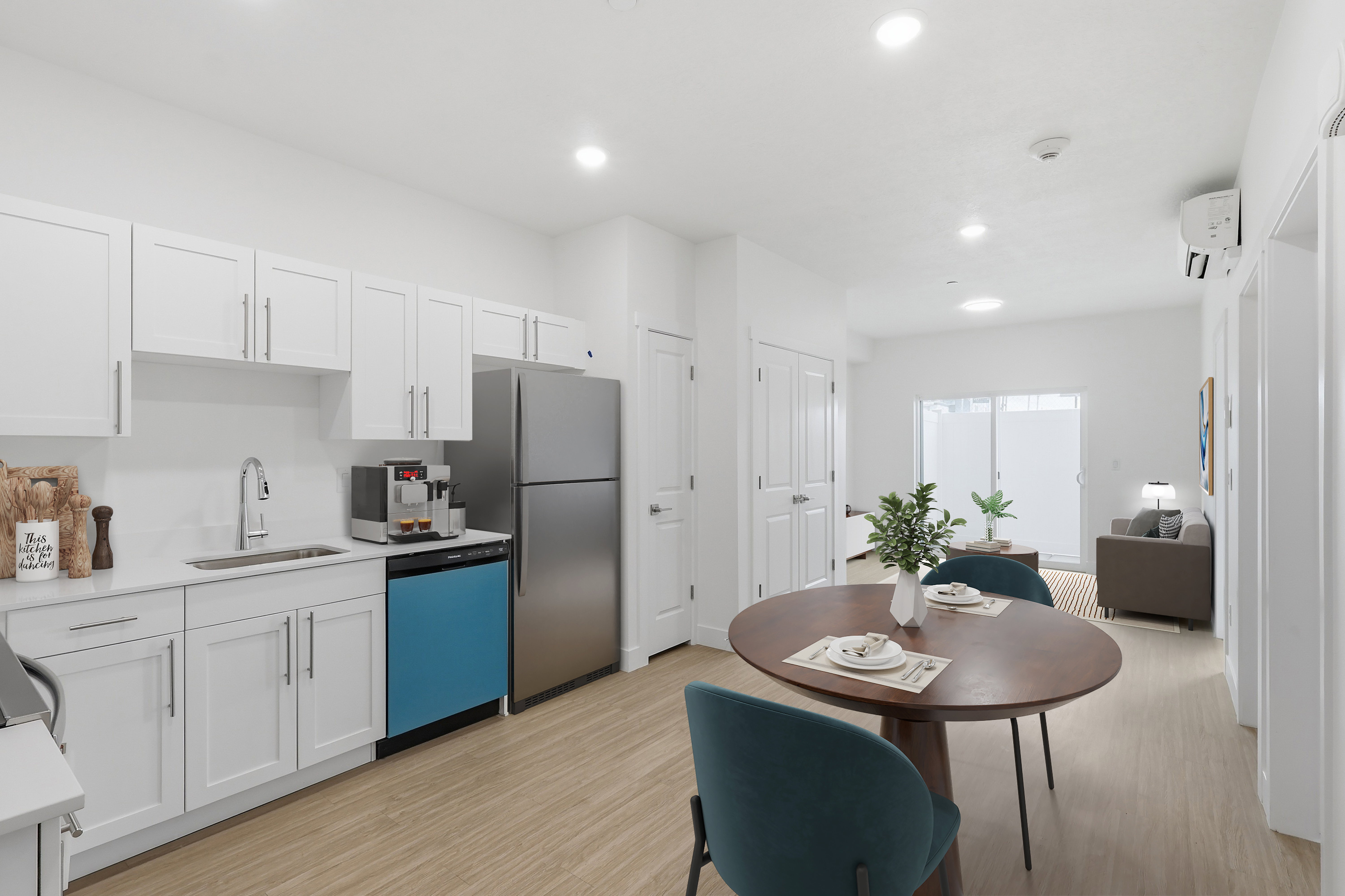 Kitchen and dining area featuring light wood-finish flooring