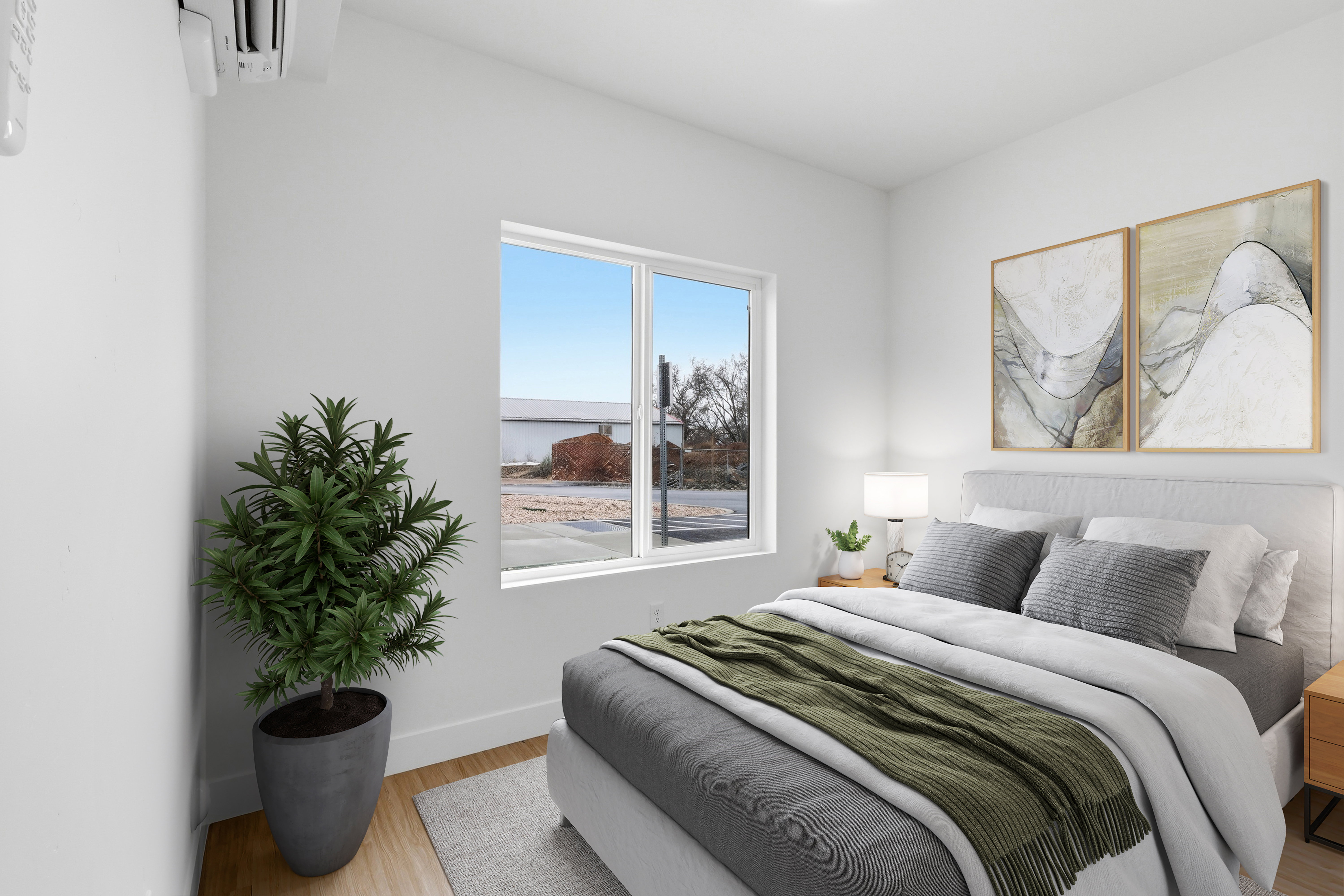 Bedroom featuring a window, white walls, and wood-finish flooring
