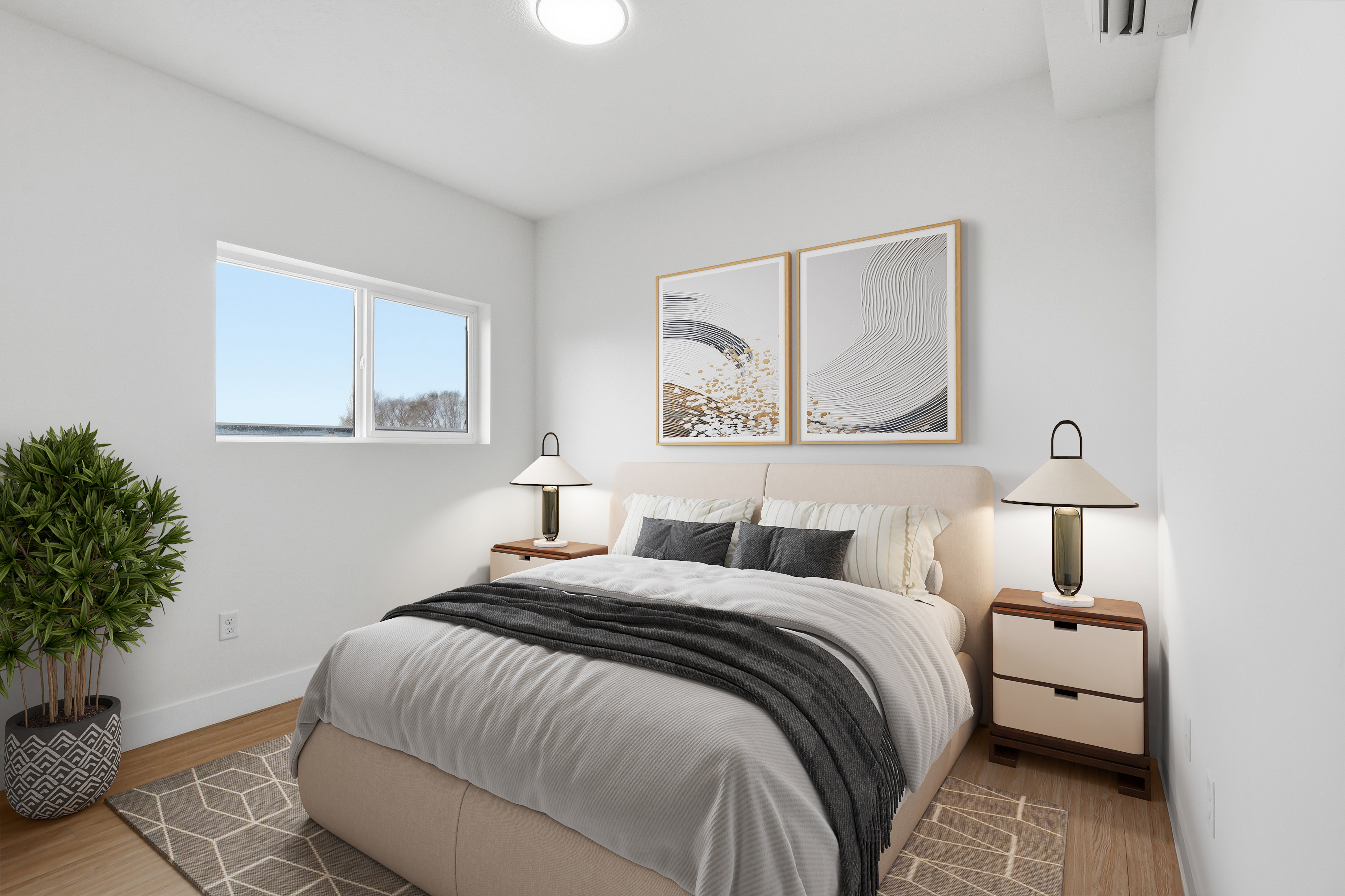 Bright bedroom featuring wood-finish flooring, white walls, and a large window