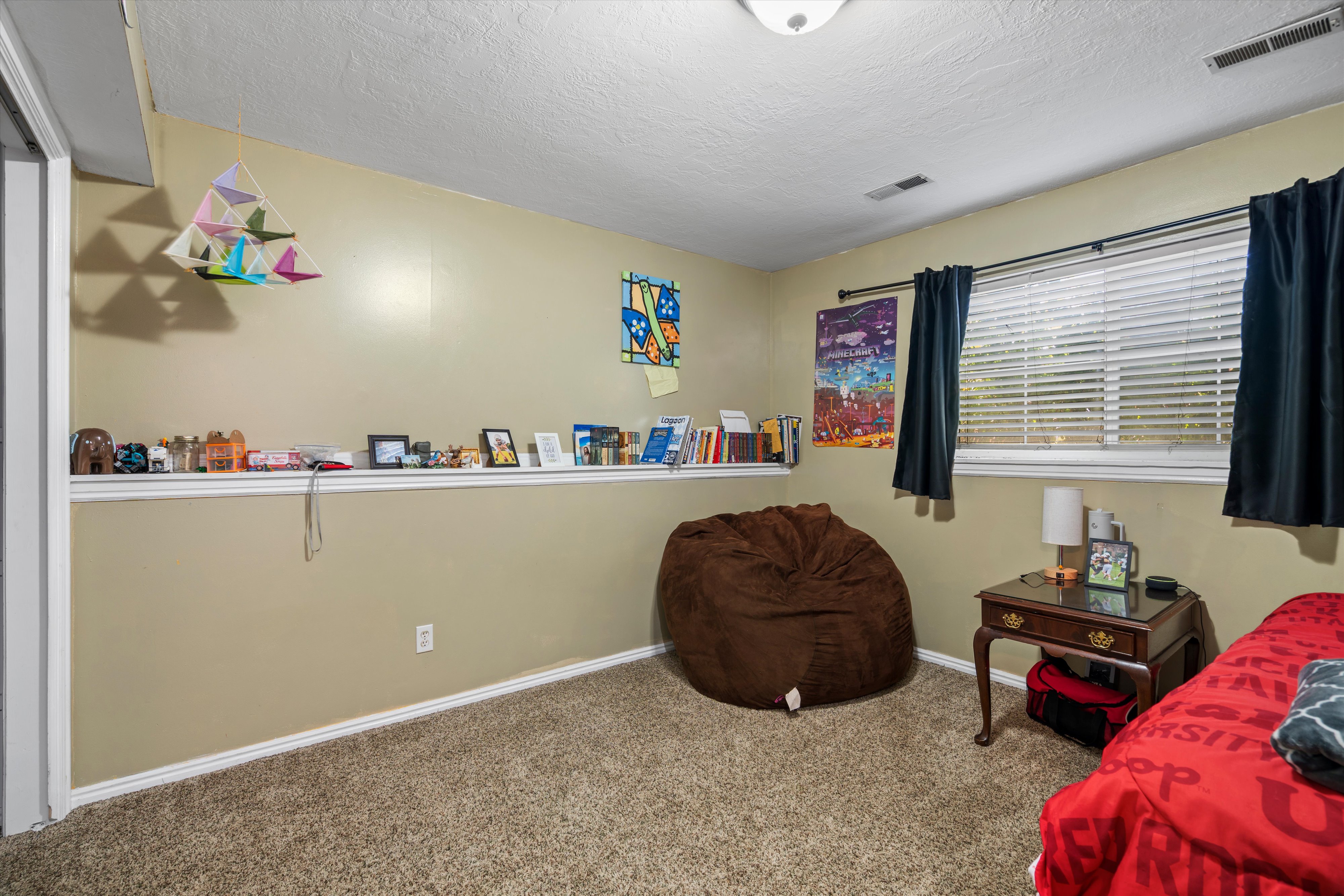 Carpeted room with a built-in wall shelf