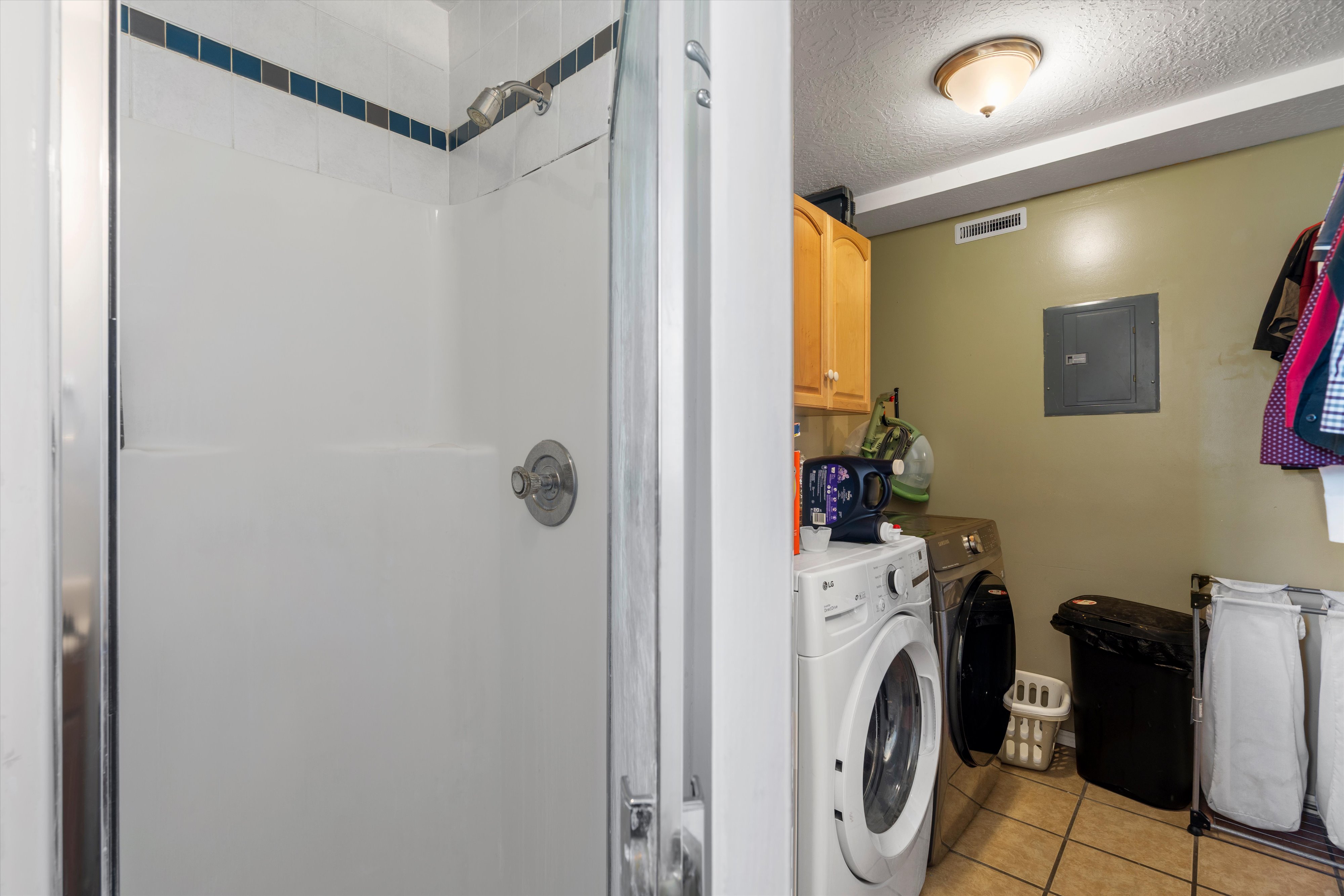Shower enclosure with white surround and chrome fixtures