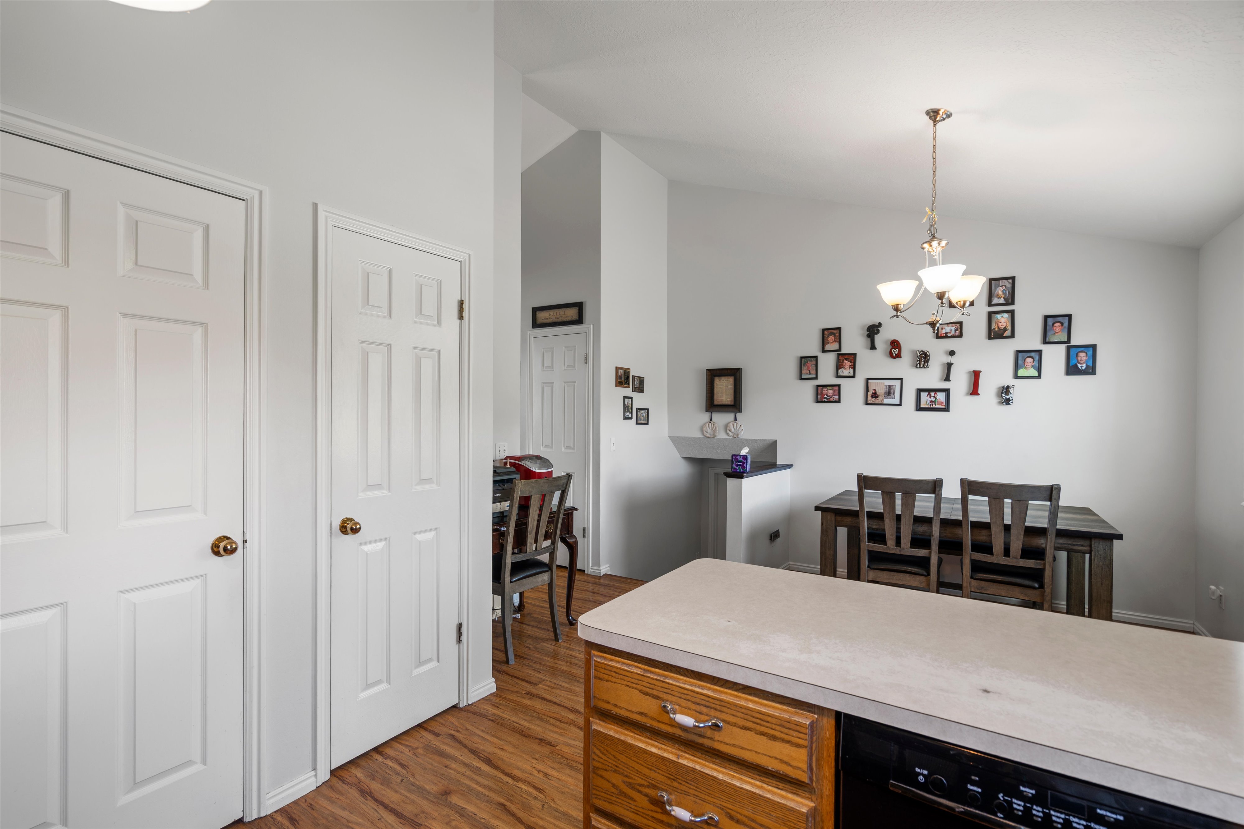 Dining area with vaulted ceilings and a bronze chandelier