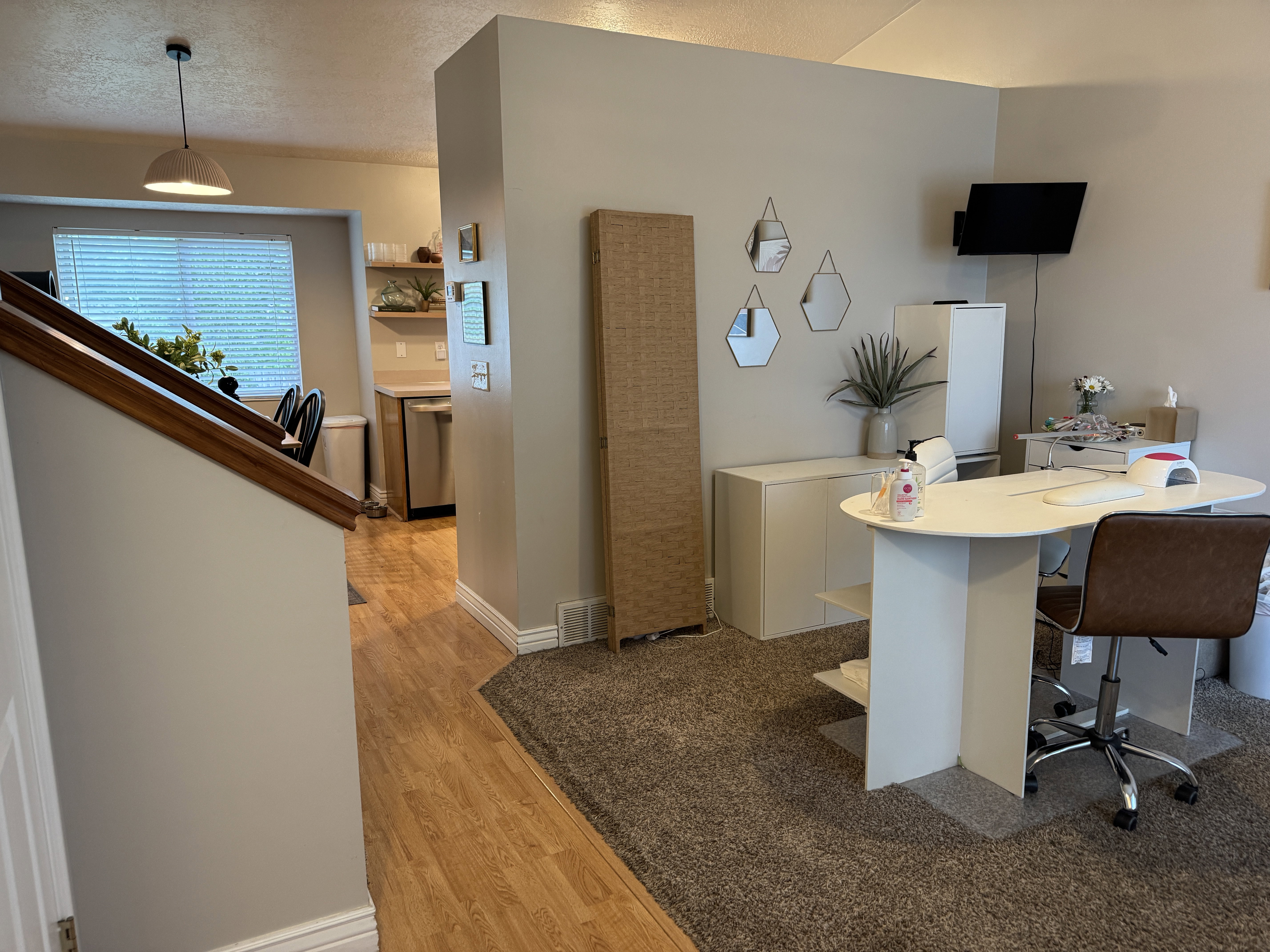 Open-concept living space featuring wood-finish flooring extending into the kitchen area