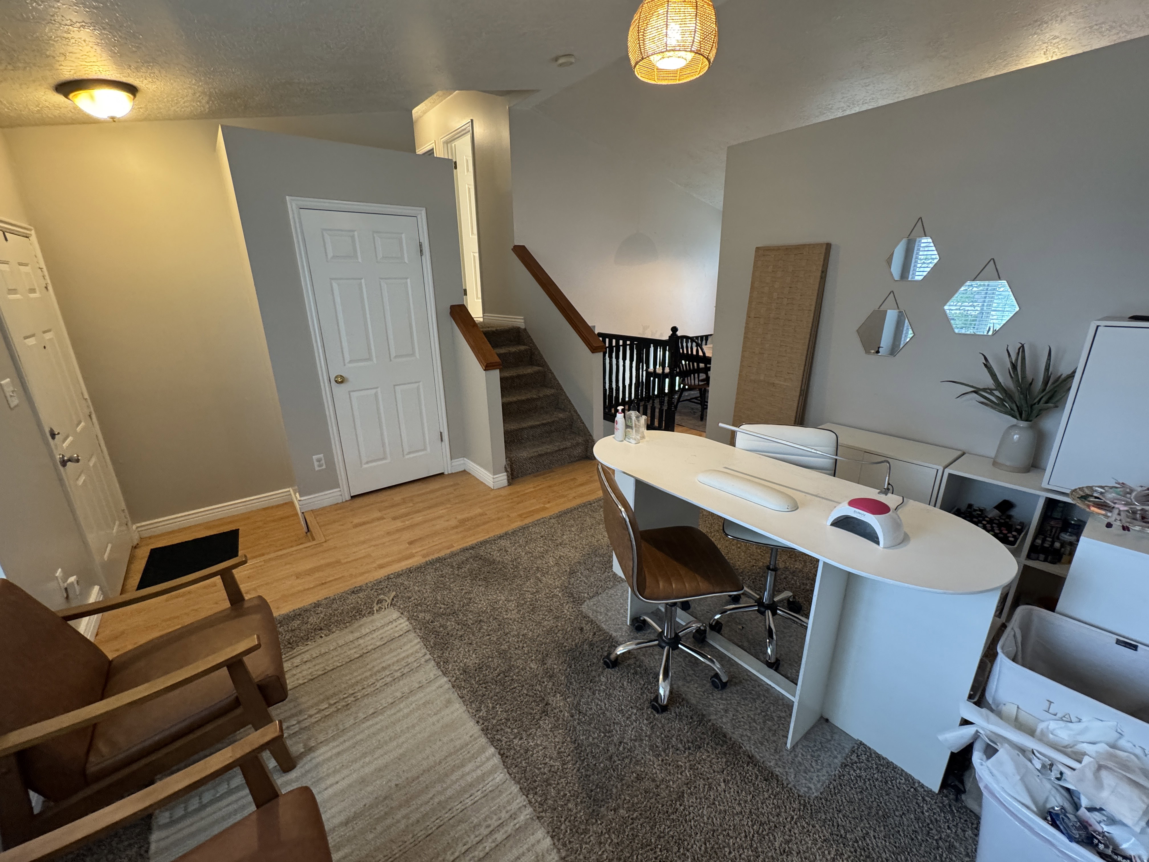 Entryway featuring wood-finish flooring, a six-panel door, and a built-in overhead light fixture
